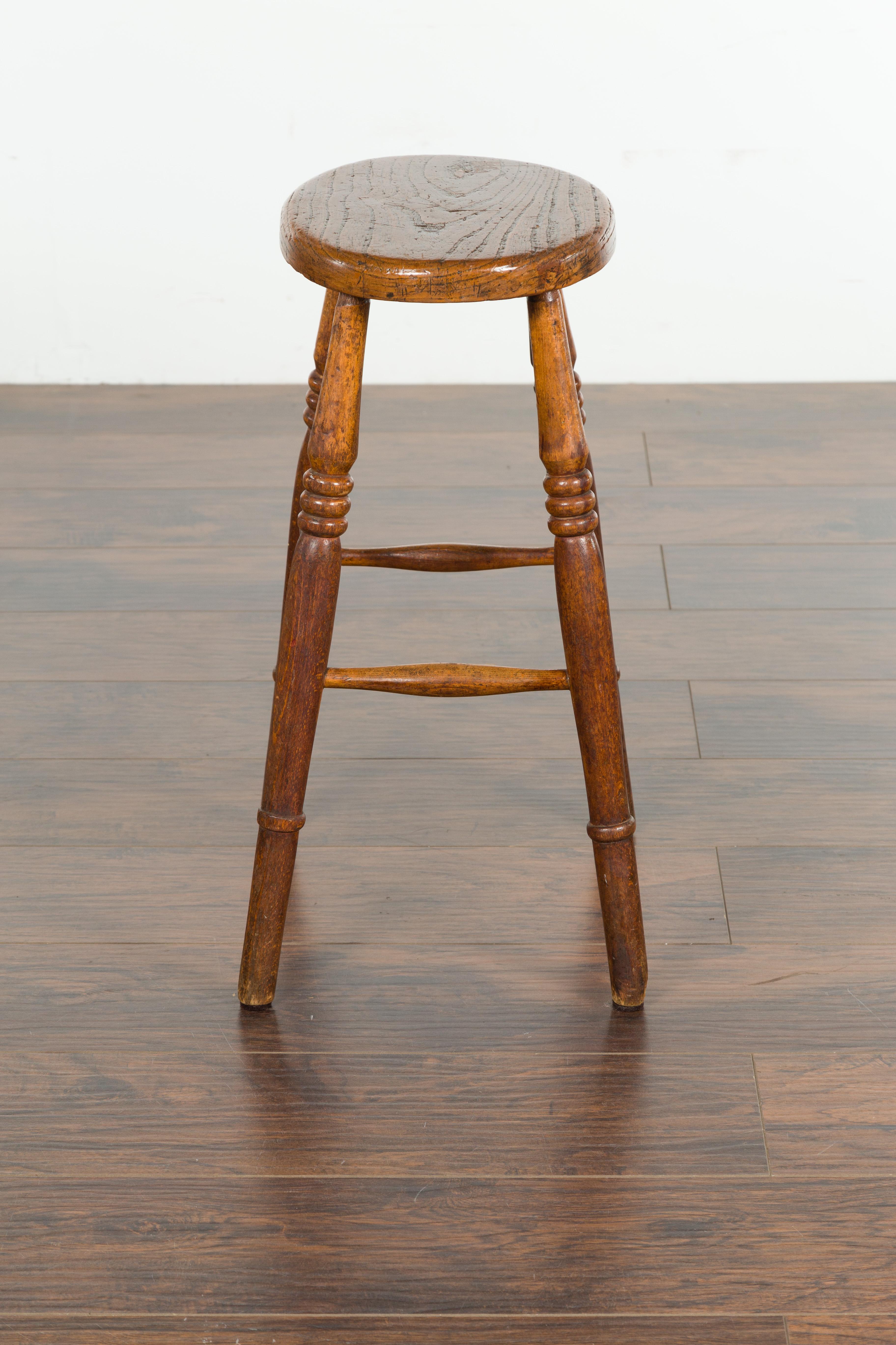 English 1880s Elm Stool with Oval Seat, Turned Splaying Legs and Side Stretchers 6