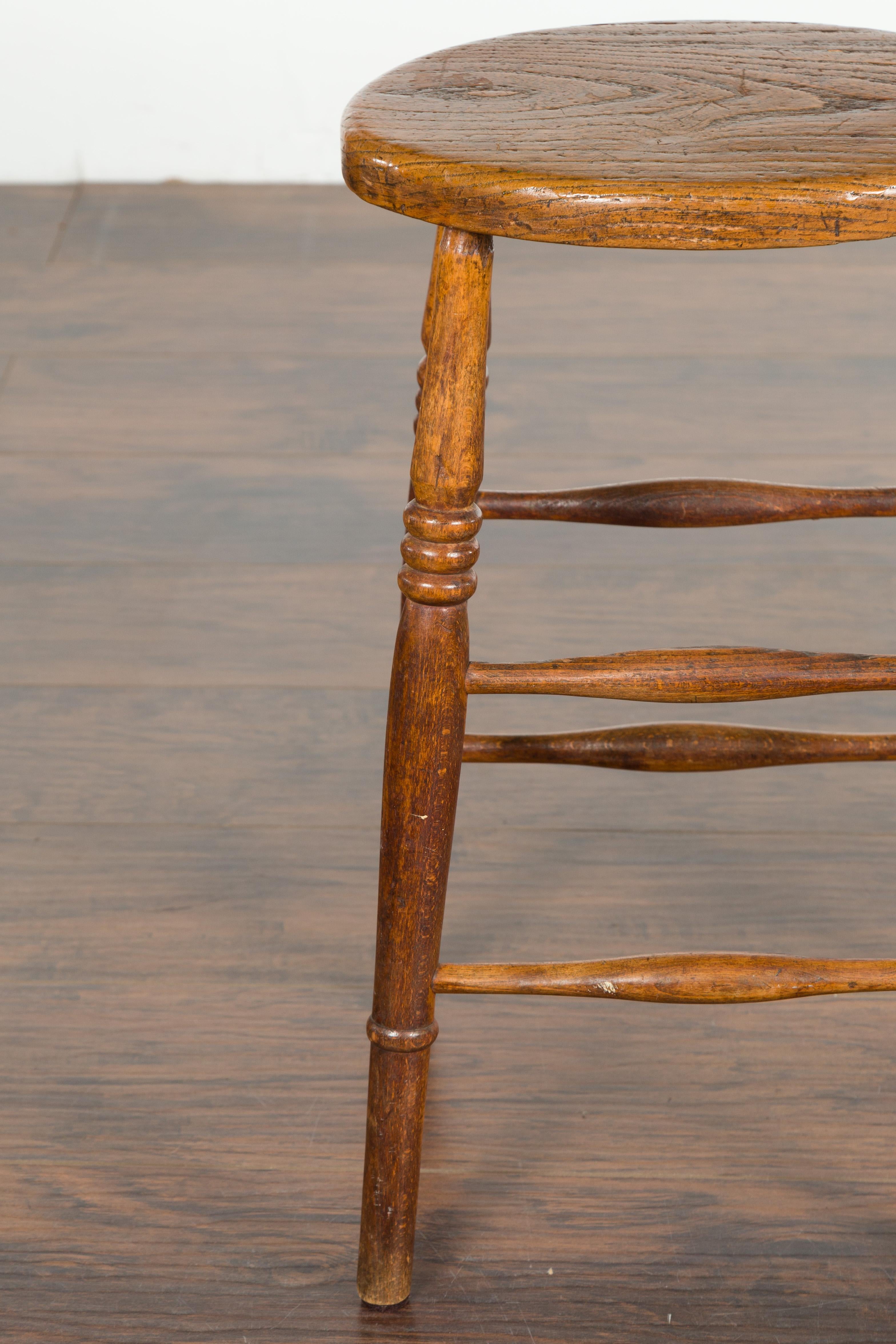 19th Century English 1880s Elm Stool with Oval Seat, Turned Splaying Legs and Side Stretchers