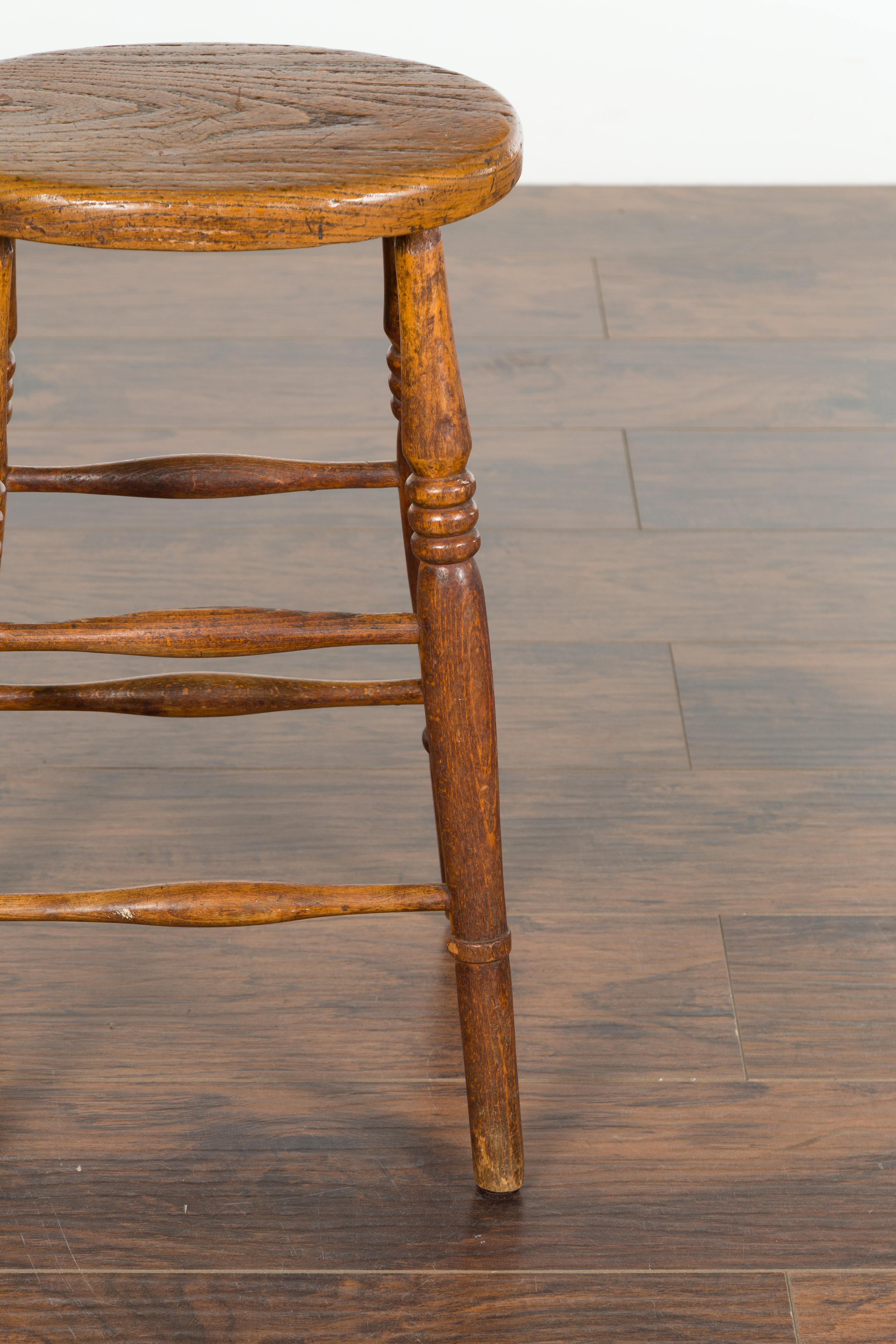 English 1880s Elm Stool with Oval Seat, Turned Splaying Legs and Side Stretchers 1