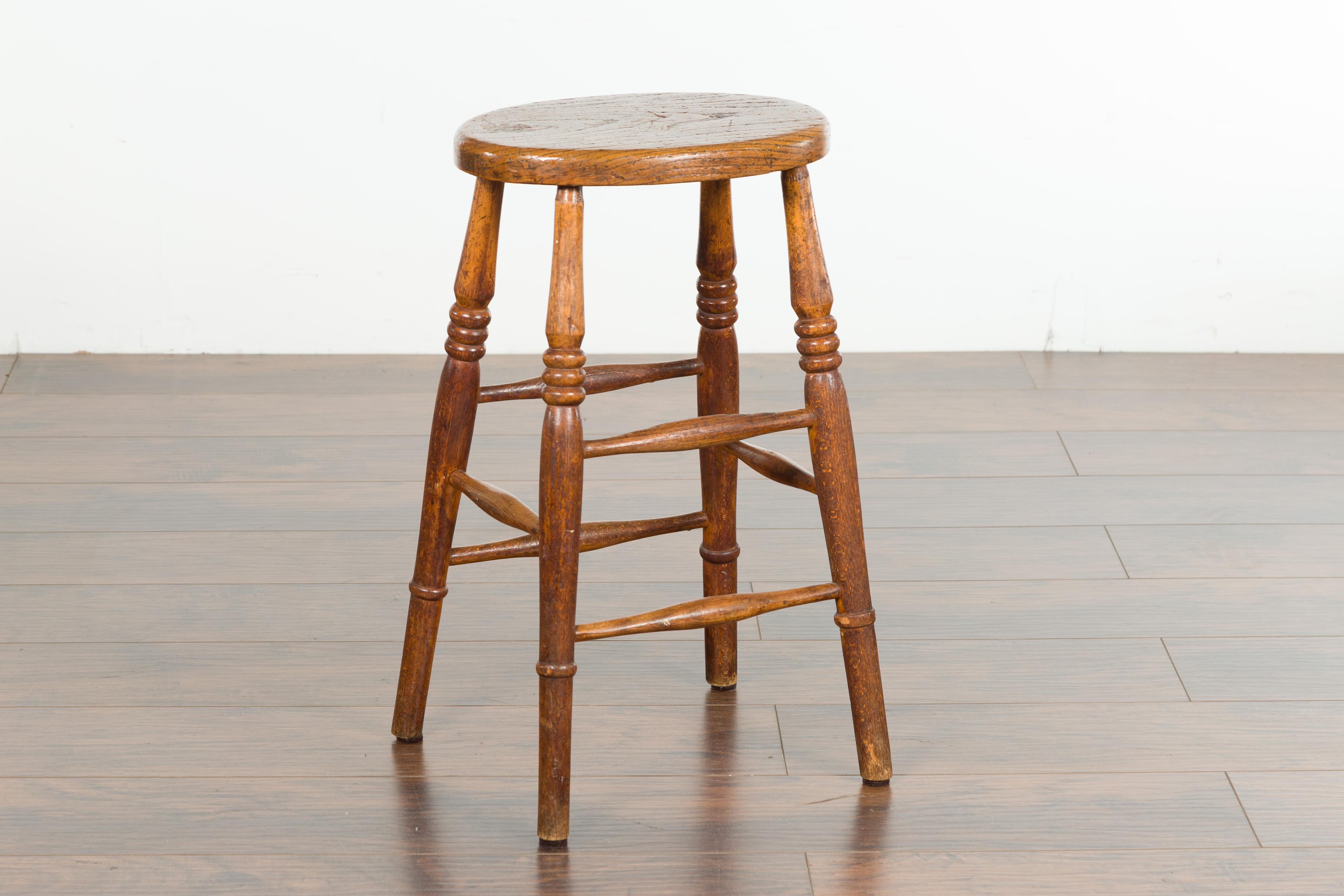English 1880s Elm Stool with Oval Seat, Turned Splaying Legs and Side Stretchers 2