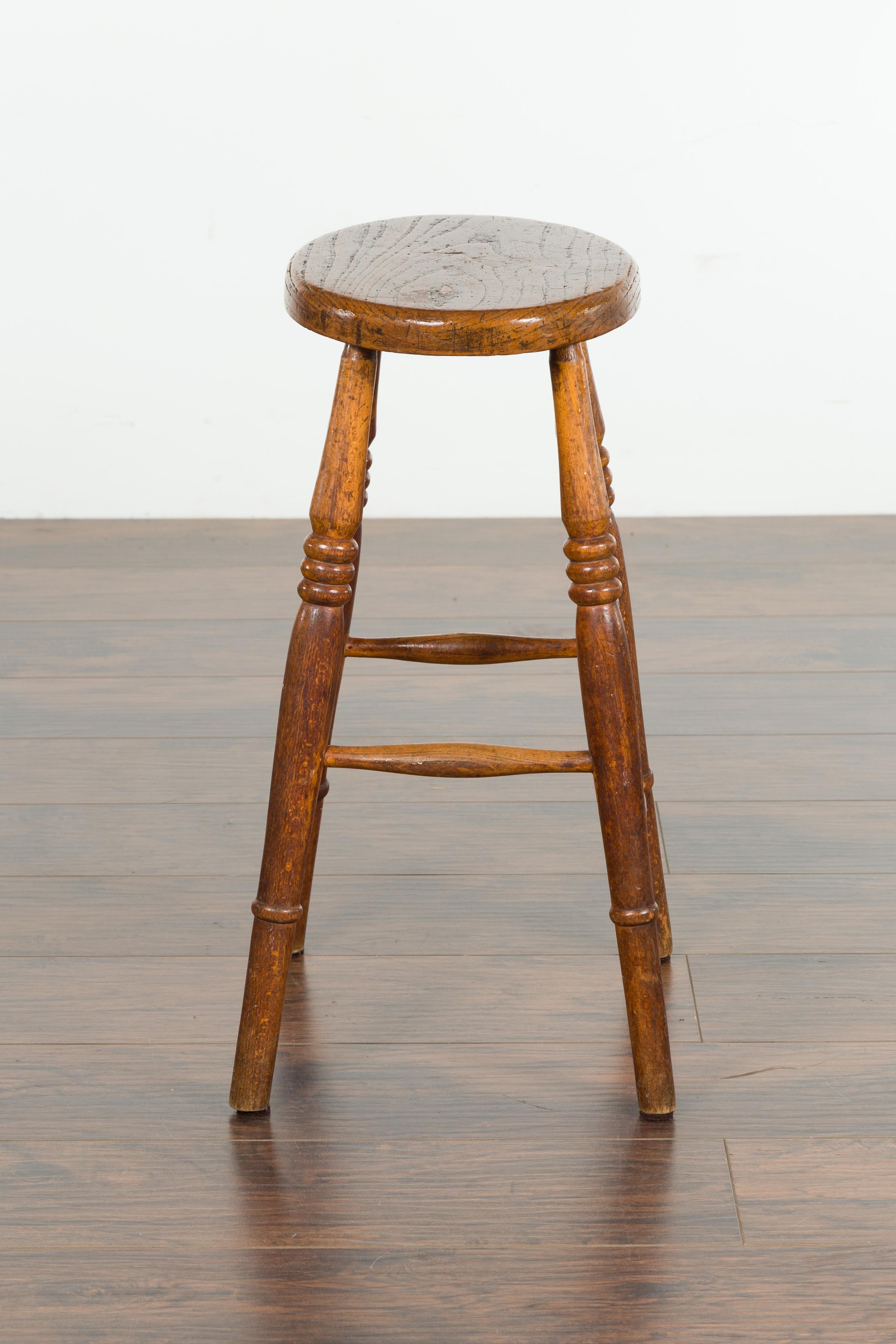 English 1880s Elm Stool with Oval Seat, Turned Splaying Legs and Side Stretchers 3