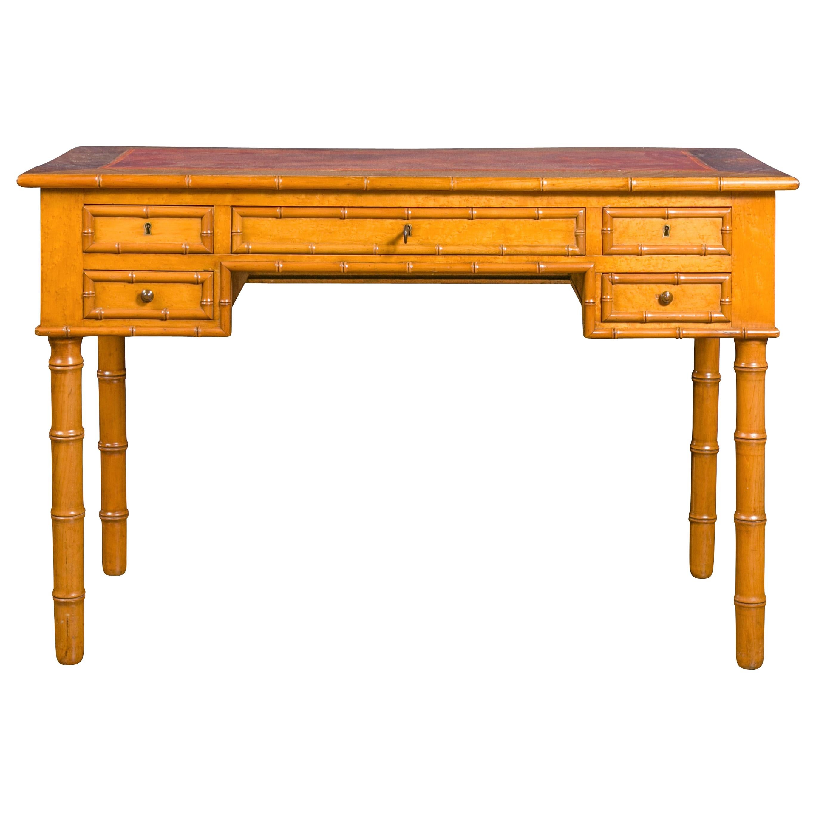 English 1880s Faux-Bamboo Desk with Copper Hued Leather Top and Five Drawers