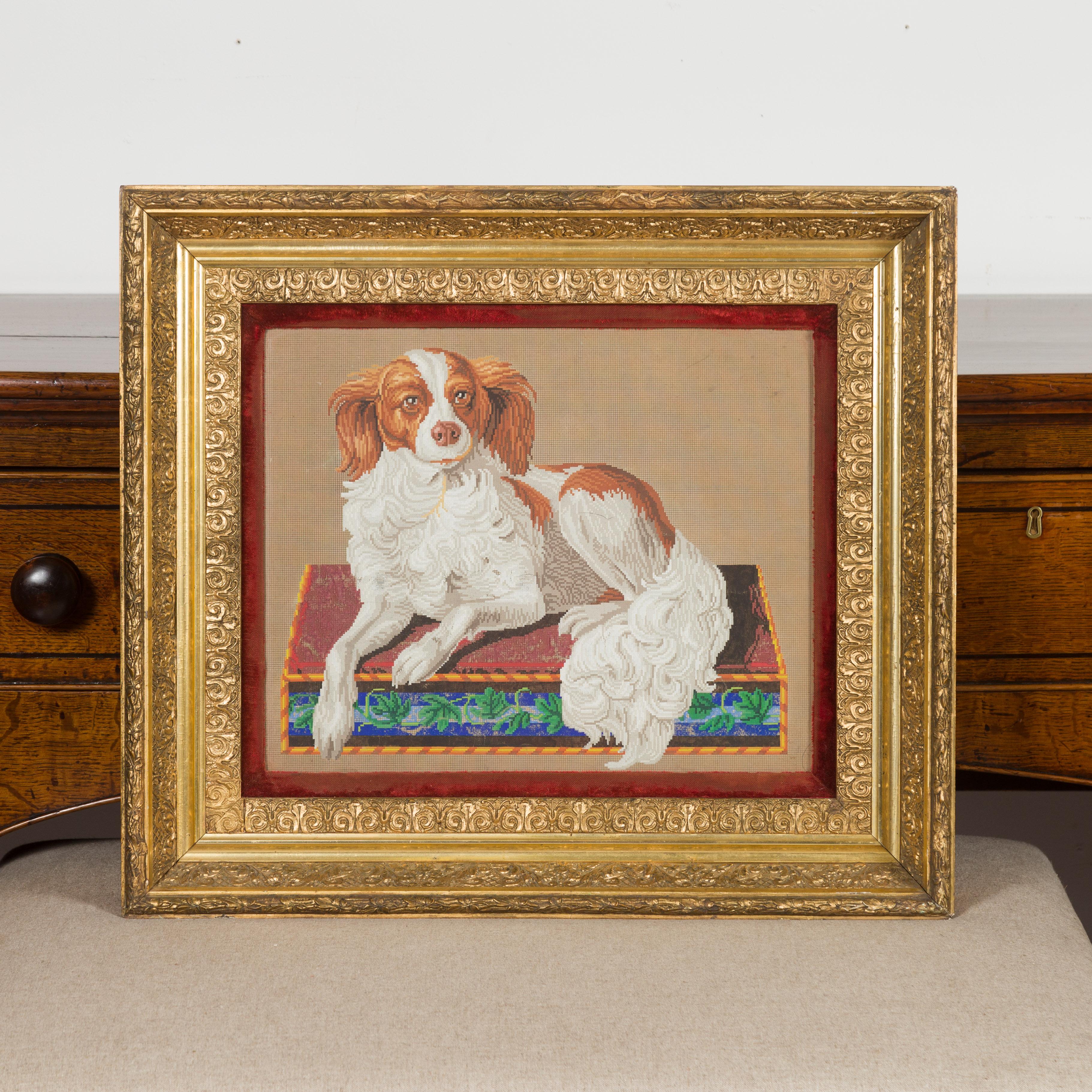 An English framed template for needlepoint from the late 19th century, depicting a spaniel. Created in England during the last quarter of the 19th century, this needlepoint template features a spaniel dog gracefully resting on a rectangular box