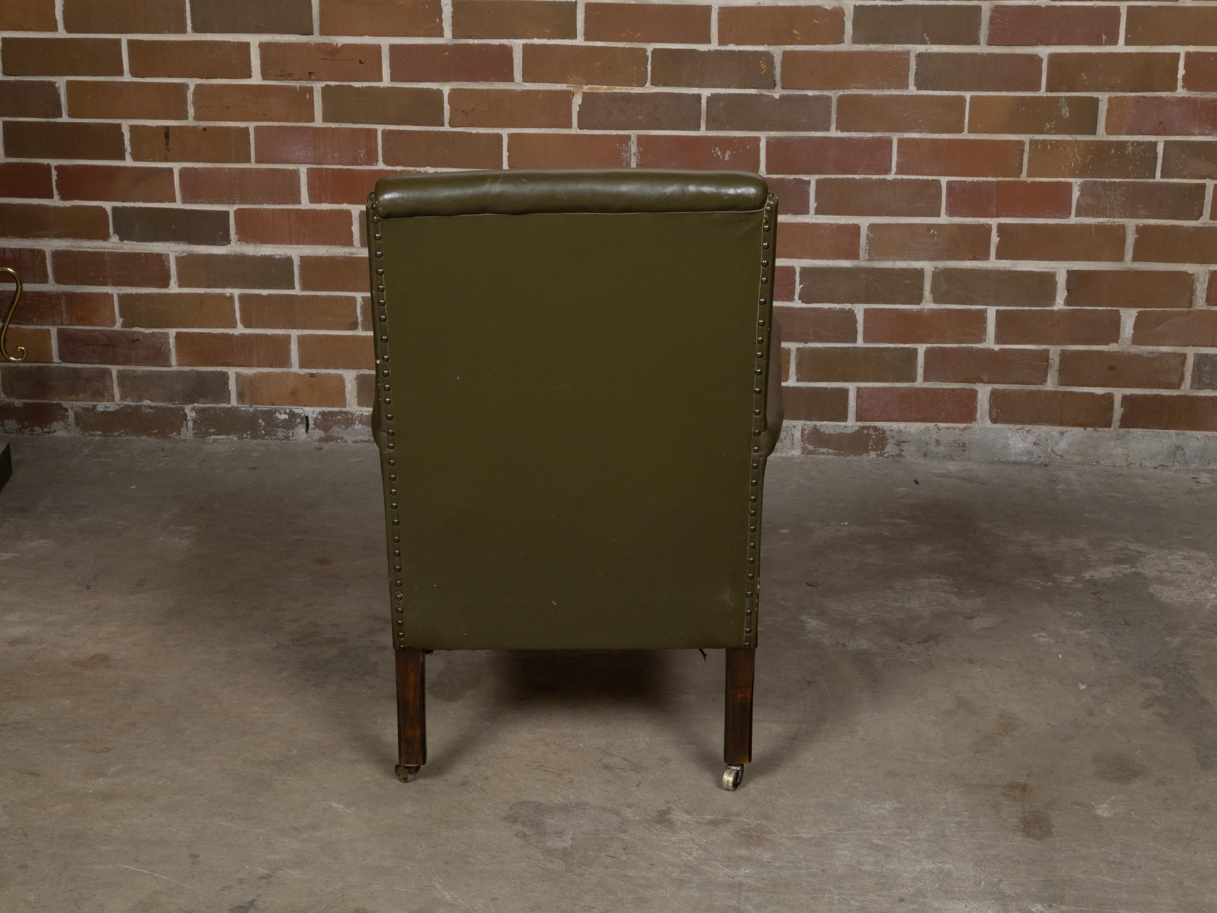English 1880s Green Tufted Leather Armchair with Turned Legs on Casters For Sale 1