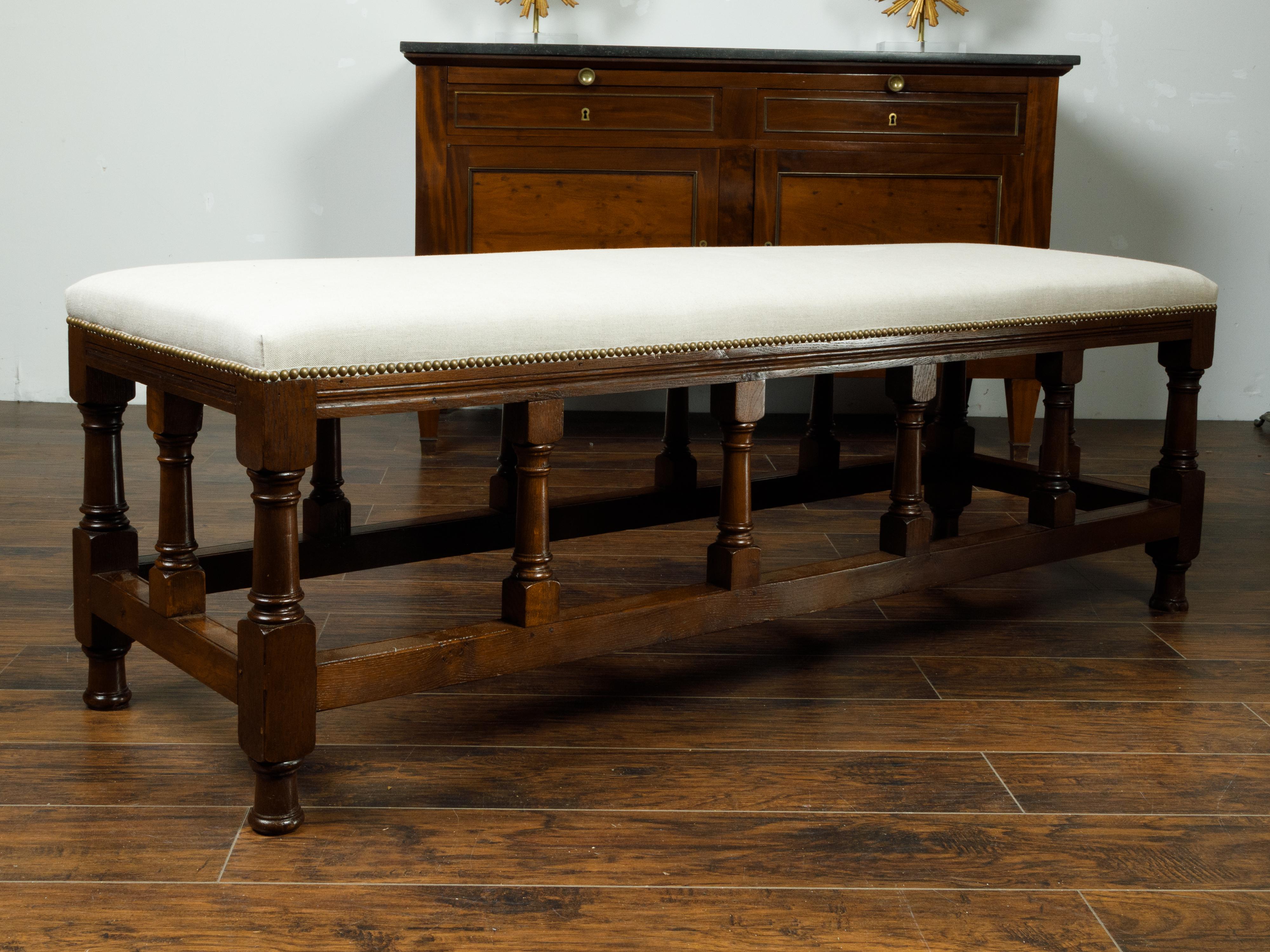 Brass English 1880s Oak Bench with Turned Legs, Side Stretchers and New Upholstery