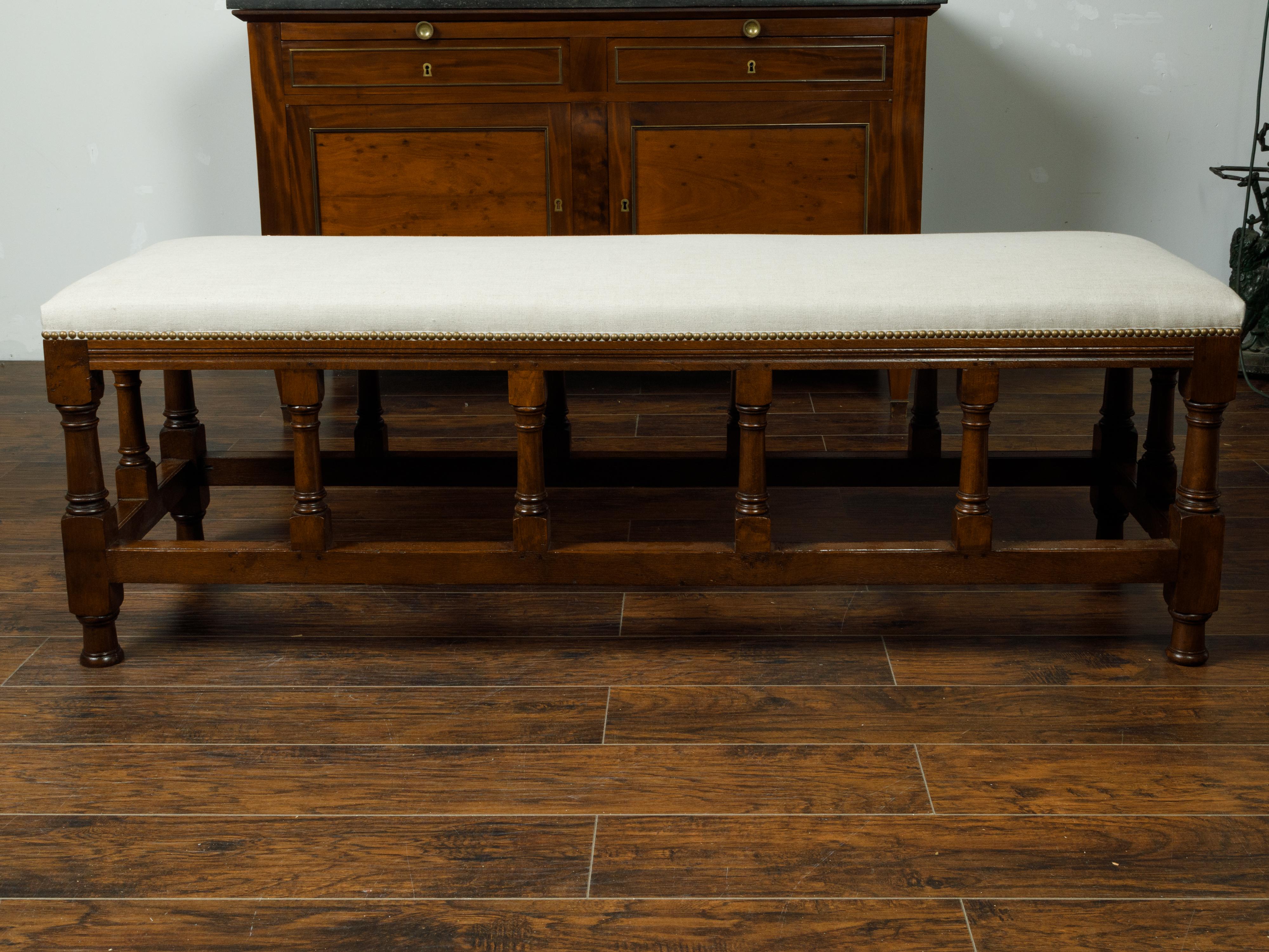 English 1880s Oak Bench with Turned Legs, Side Stretchers and New Upholstery 2