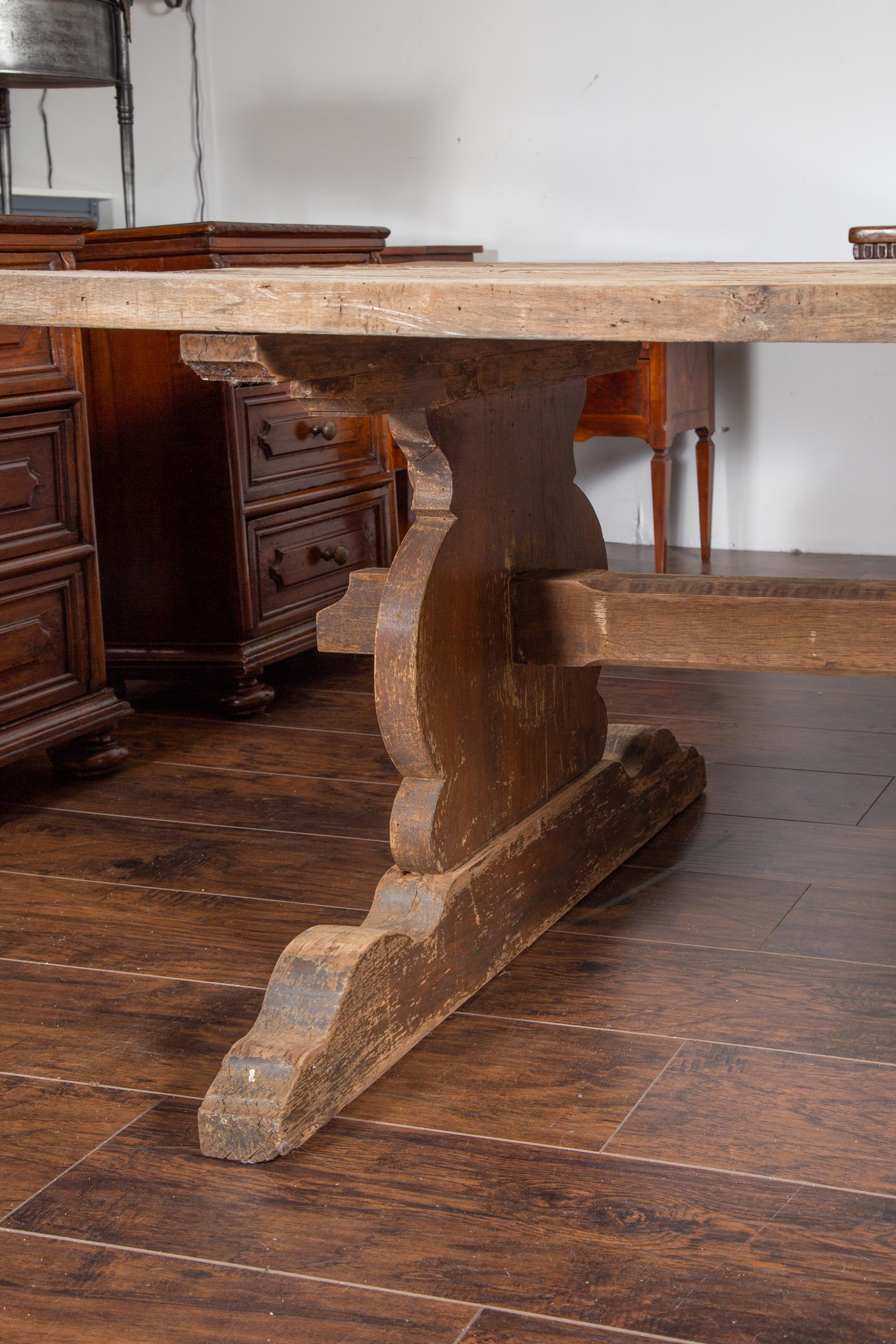19th Century English 1880s Oak Farm Dining Table with Carved Trestle Base and Aged Patina
