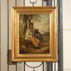 Huile sur toile anglaise des années 1880 représentant un garçon et son chien dans un cadre doré ancien