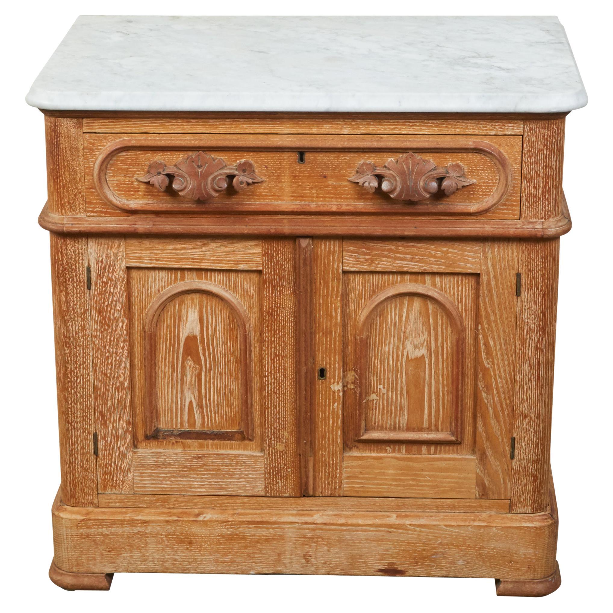 English 1880s Small Cabinet with White Marble Top, Carved Drawer and Two Doors