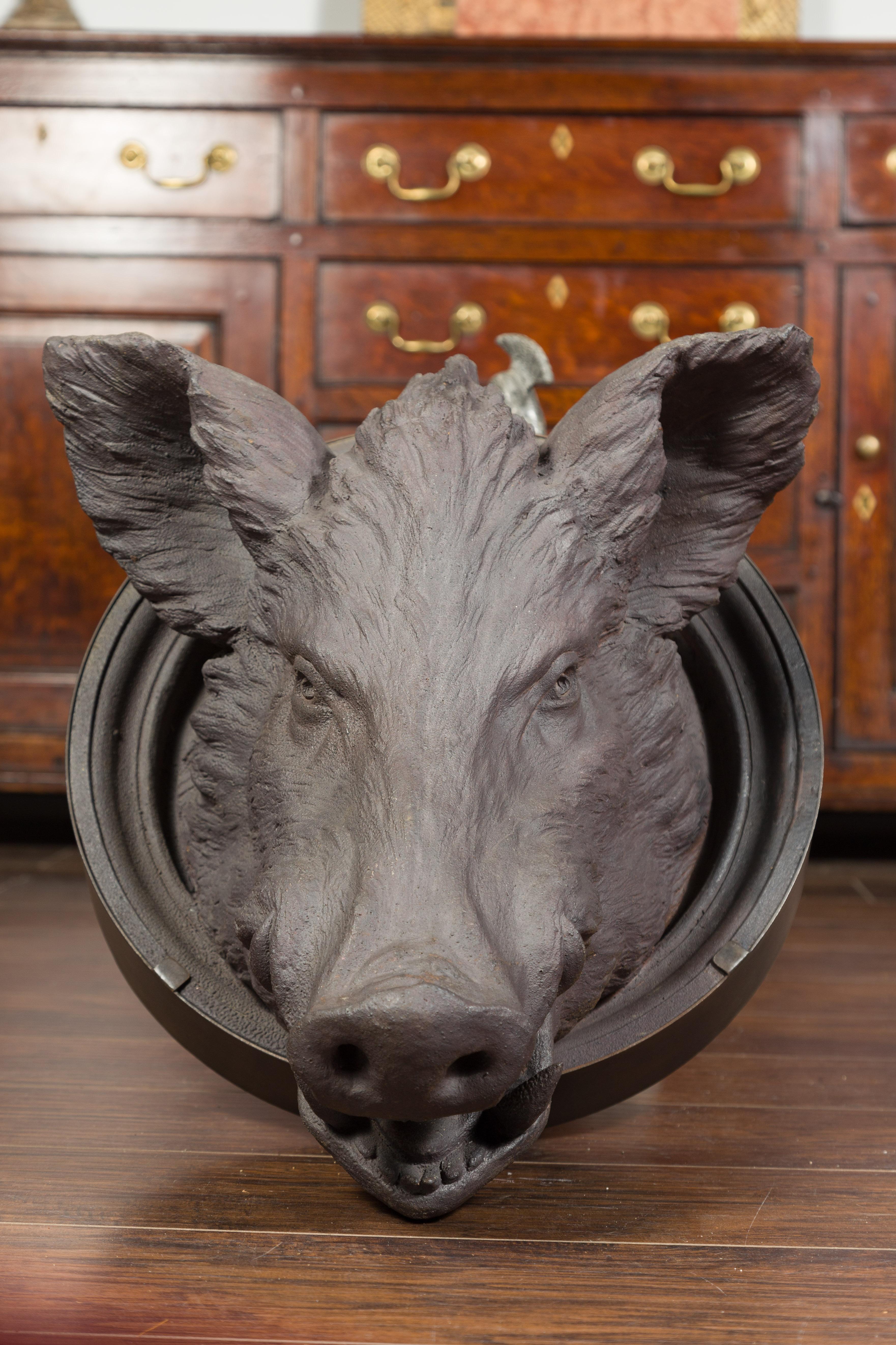 An English terracotta hog head from the late 19th century, with new custom iron frame. Created in England during the last quarter of the 19th century, this terracotta hog head has been mounted on a new custom made circular iron frame. Its mouth