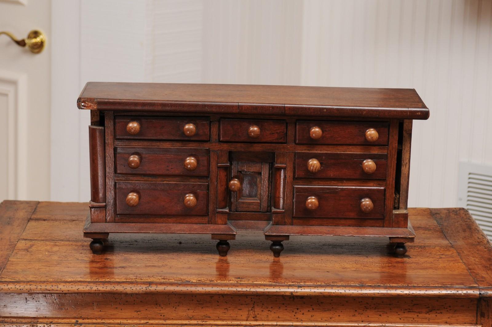 English 1890s Miniature Chest with Seven Drawers, Semi Columns and Turnip Feet 12