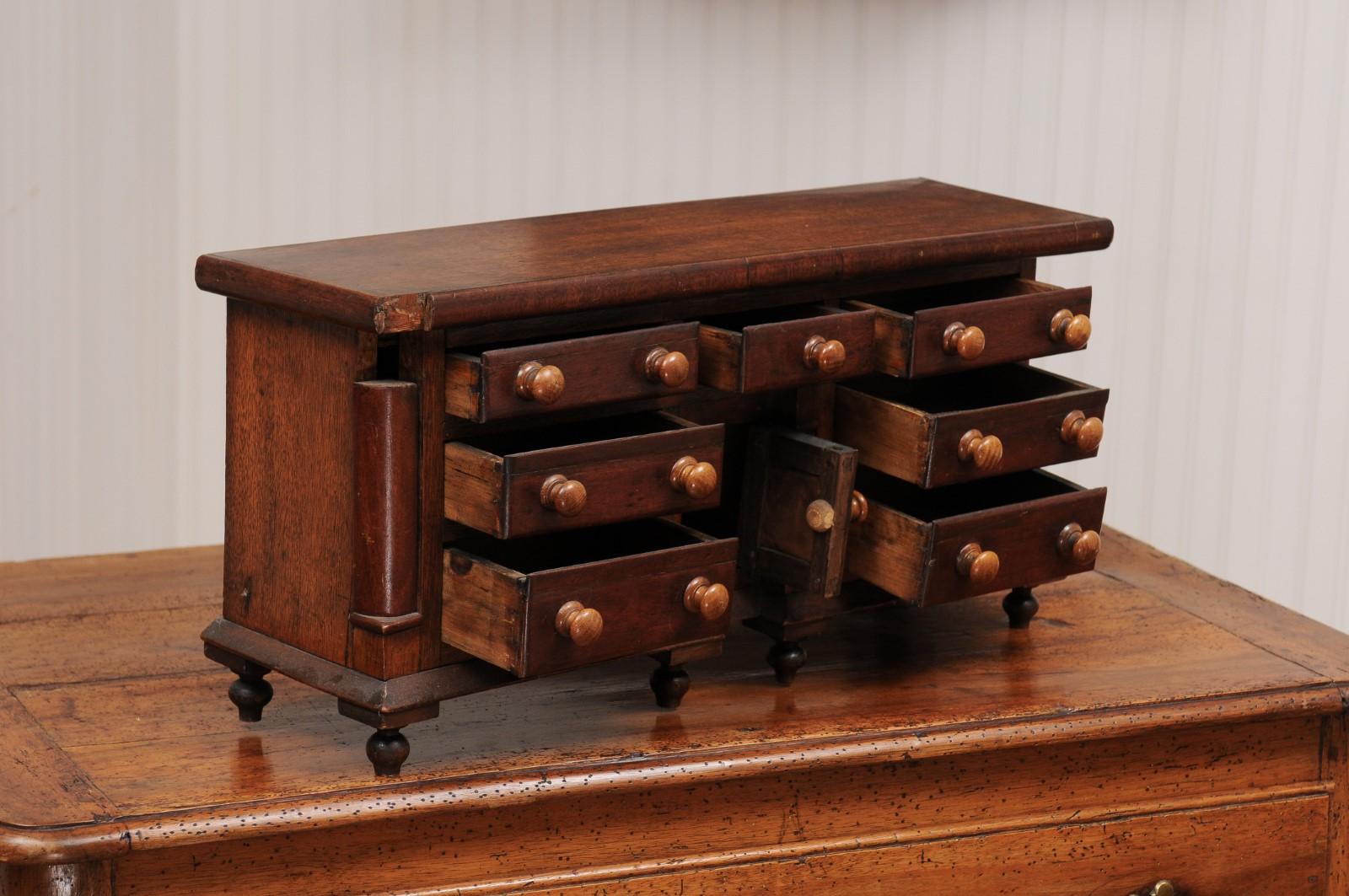 English 1890s Miniature Chest with Seven Drawers, Semi Columns and Turnip Feet 1