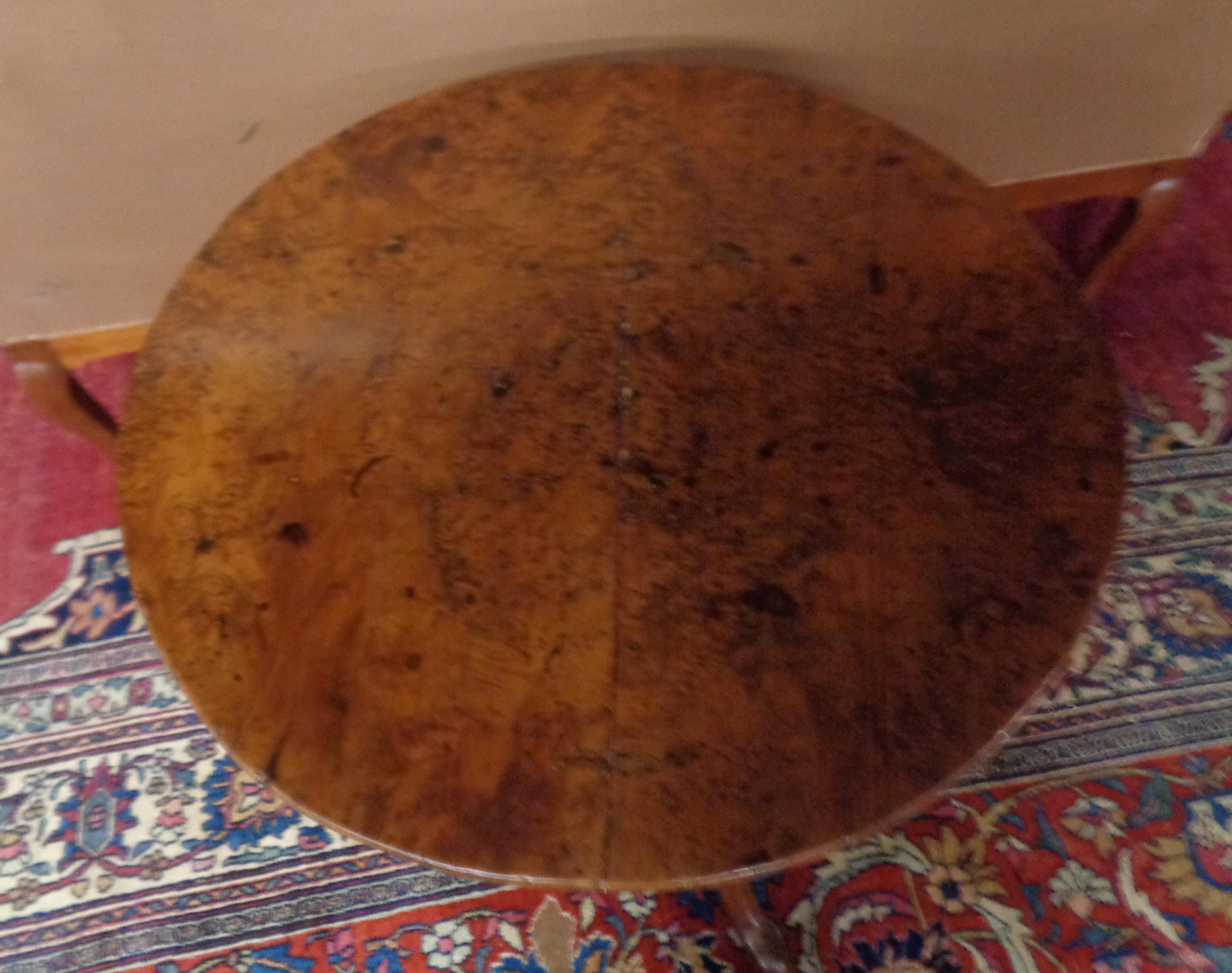 Rare English burled yew wood circular tripod table with a pedestal base. The table has a solid yew wood turned pedestal base with three yew wood feet. It is very rare to have a burled and solid tripod table. It has very rich color and patina, circa
