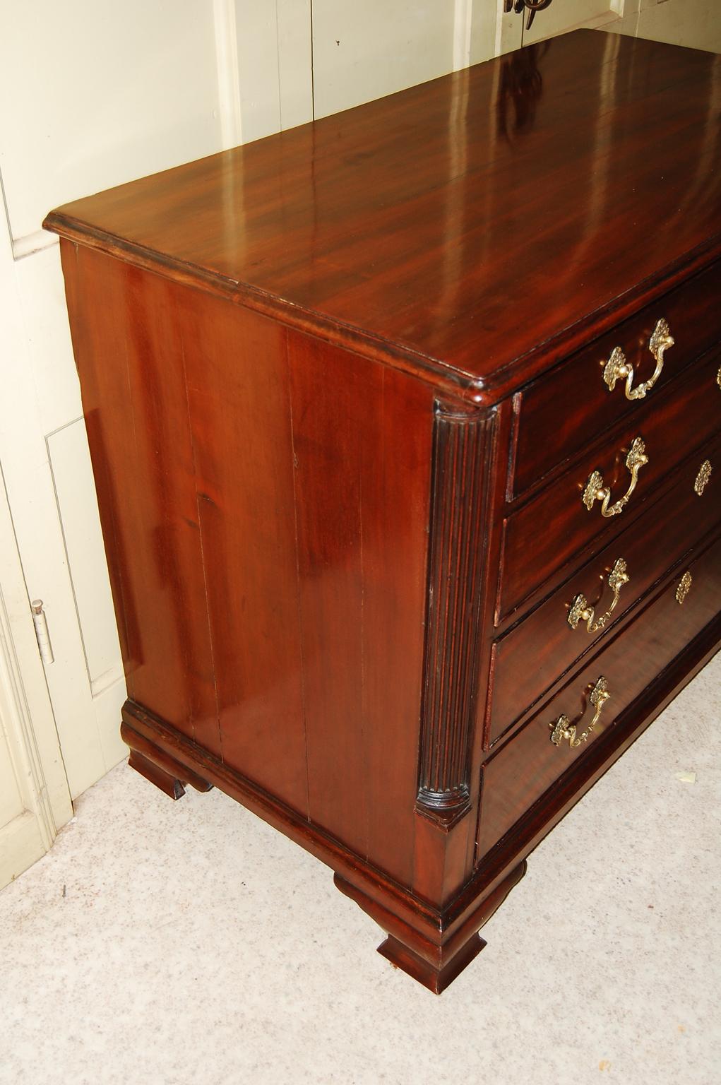   English Georgian Chippendale mahogany gentleman's chest of four graduated drawers.  This fine chest has a  mahogany fitted top drawer with sliding baize inlaid dressing panel that when slid back reveals small drawers and open compartments for
