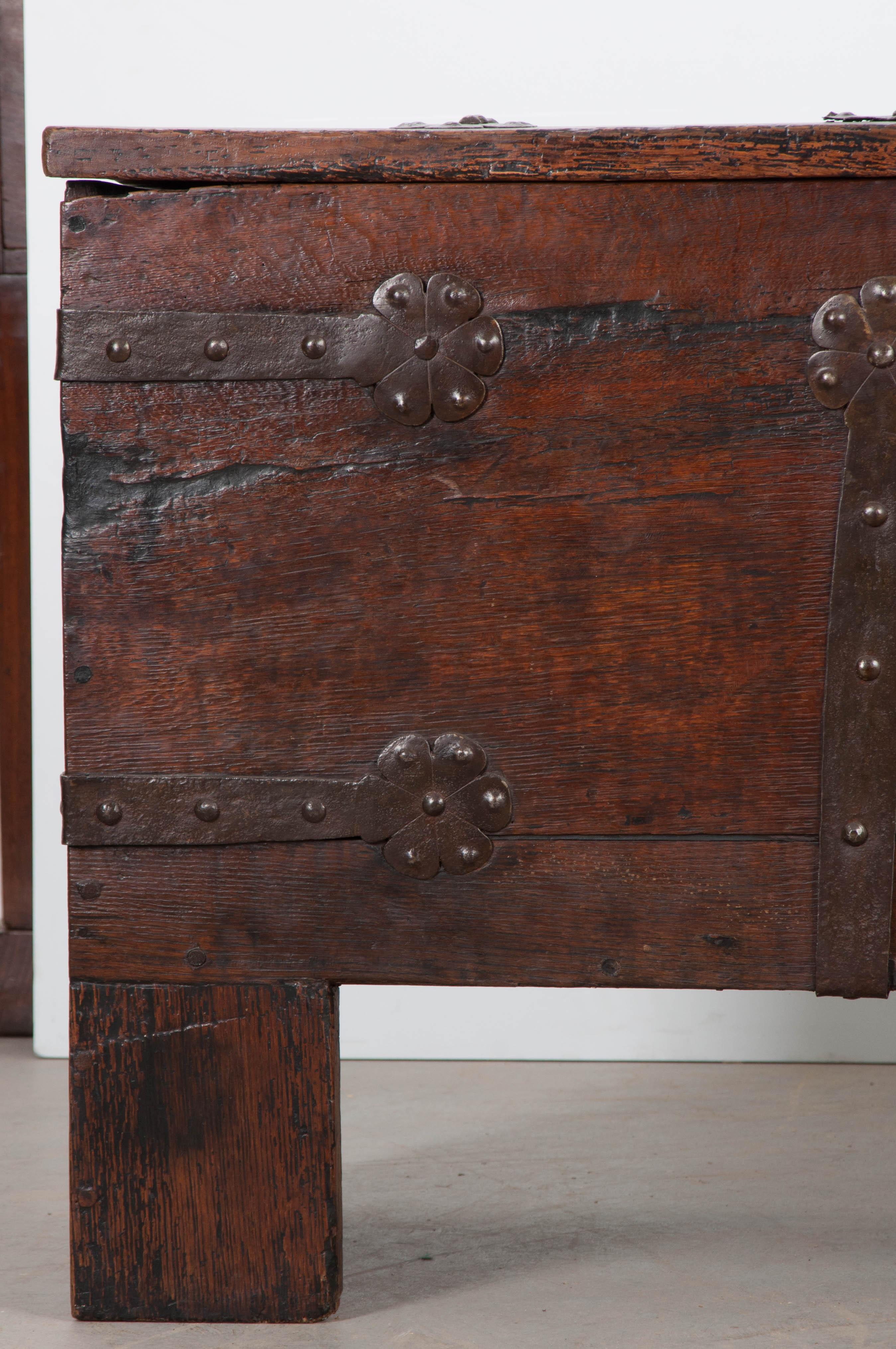 A large 18th century oak trunk, bound in iron, from Spain. This case piece was made using thick boards of solid oak. They have acquired an incredible antique patina over the centuries. The trunk’s contents can be secured thanks to the impressive