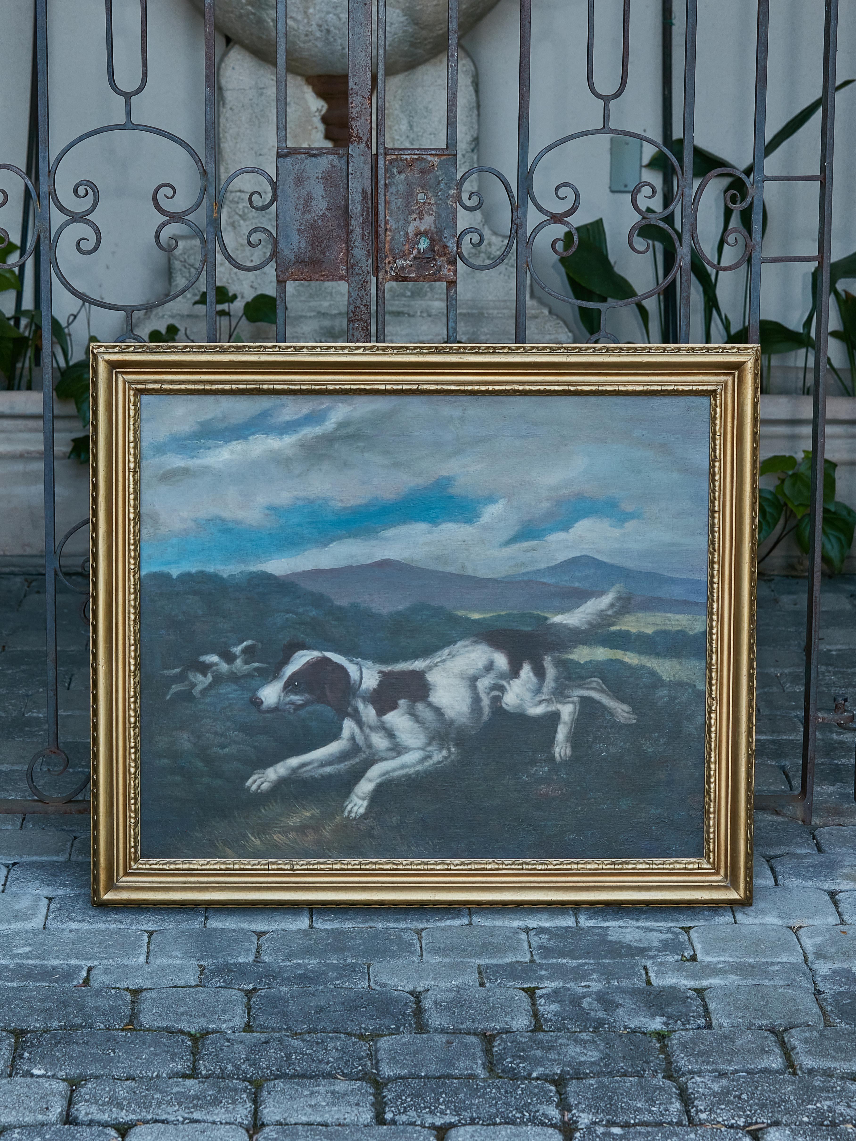 An English oil on canvas hunting dog painting from the late 18th century in carved giltwood frame. Elevate your art collection with this captivating English oil on canvas painting from the late 18th century. Depicting a scene of two hunting dogs