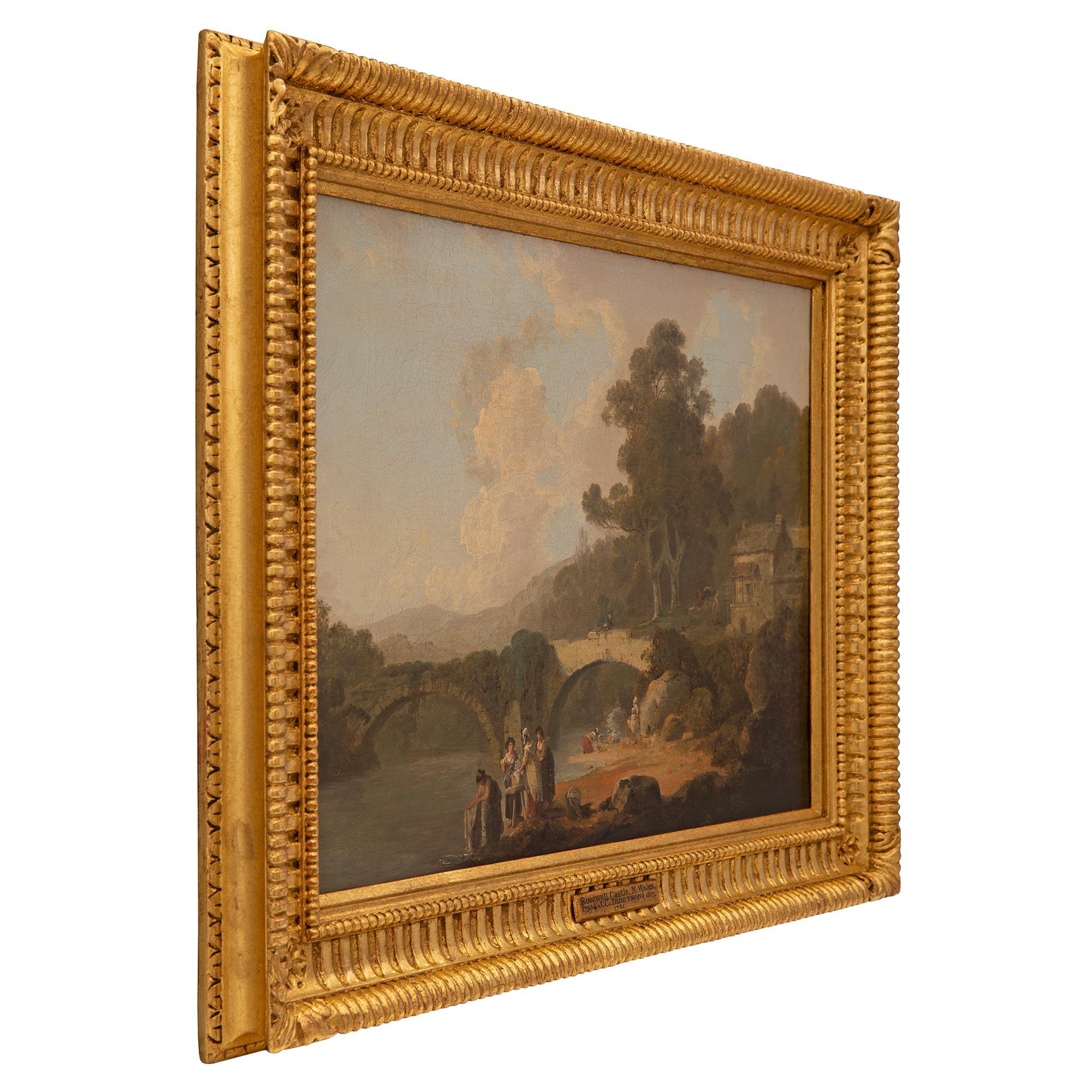 A beautiful and very high quality English 18th century oil on canvas painting named Rosewood Castle, N. Wales by Julius Caesar Ibbetson circa 1781. The wonderfully executed painting depicts washerwomen cleaning clothes in the river near a Bridge at
