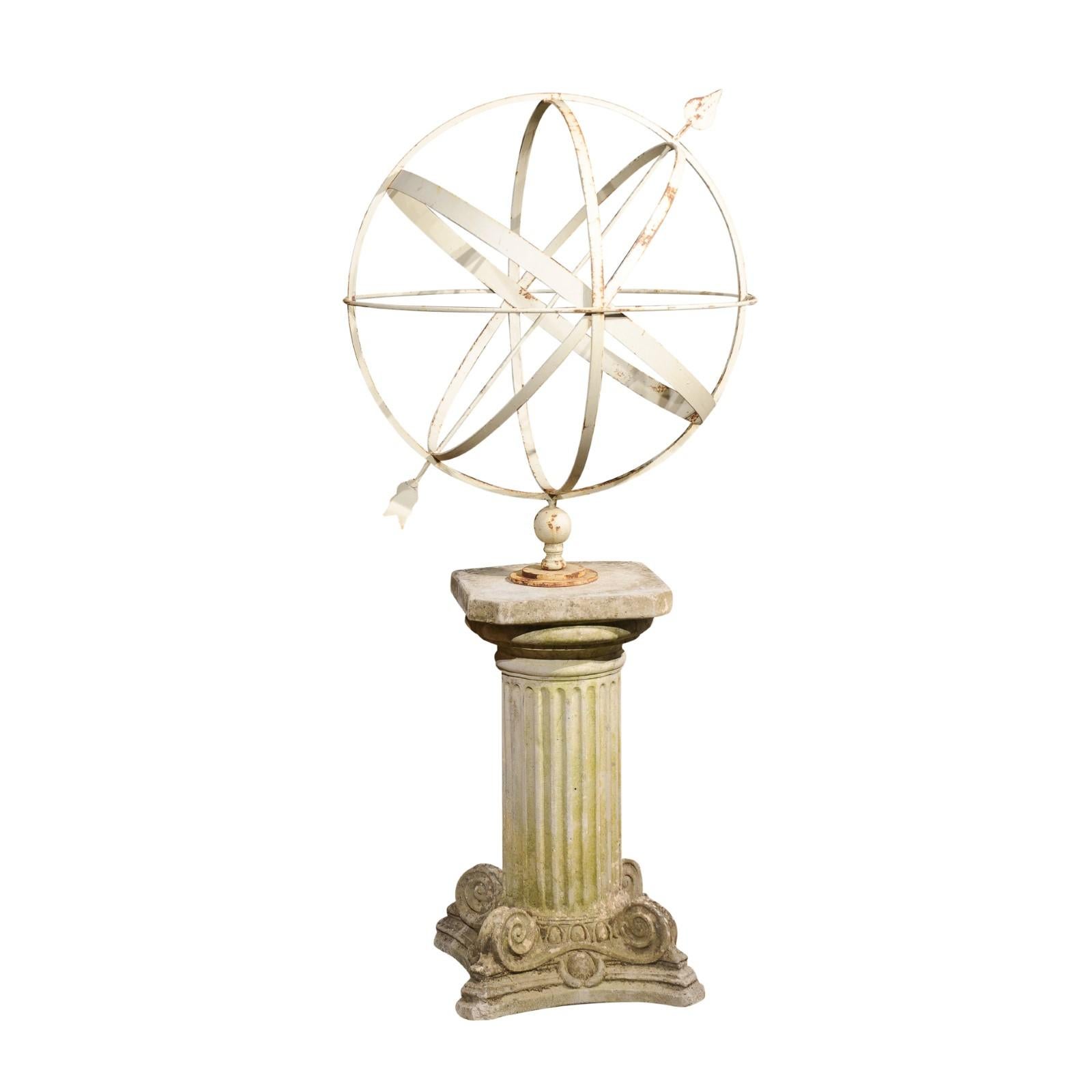 An English Turn of the Century armillary sphere from the early 20th century with Ionic style stone pedestal and rustic character. Created in England during the Turn of the Century which saw the transition from the 19th to the 20th, this armillary