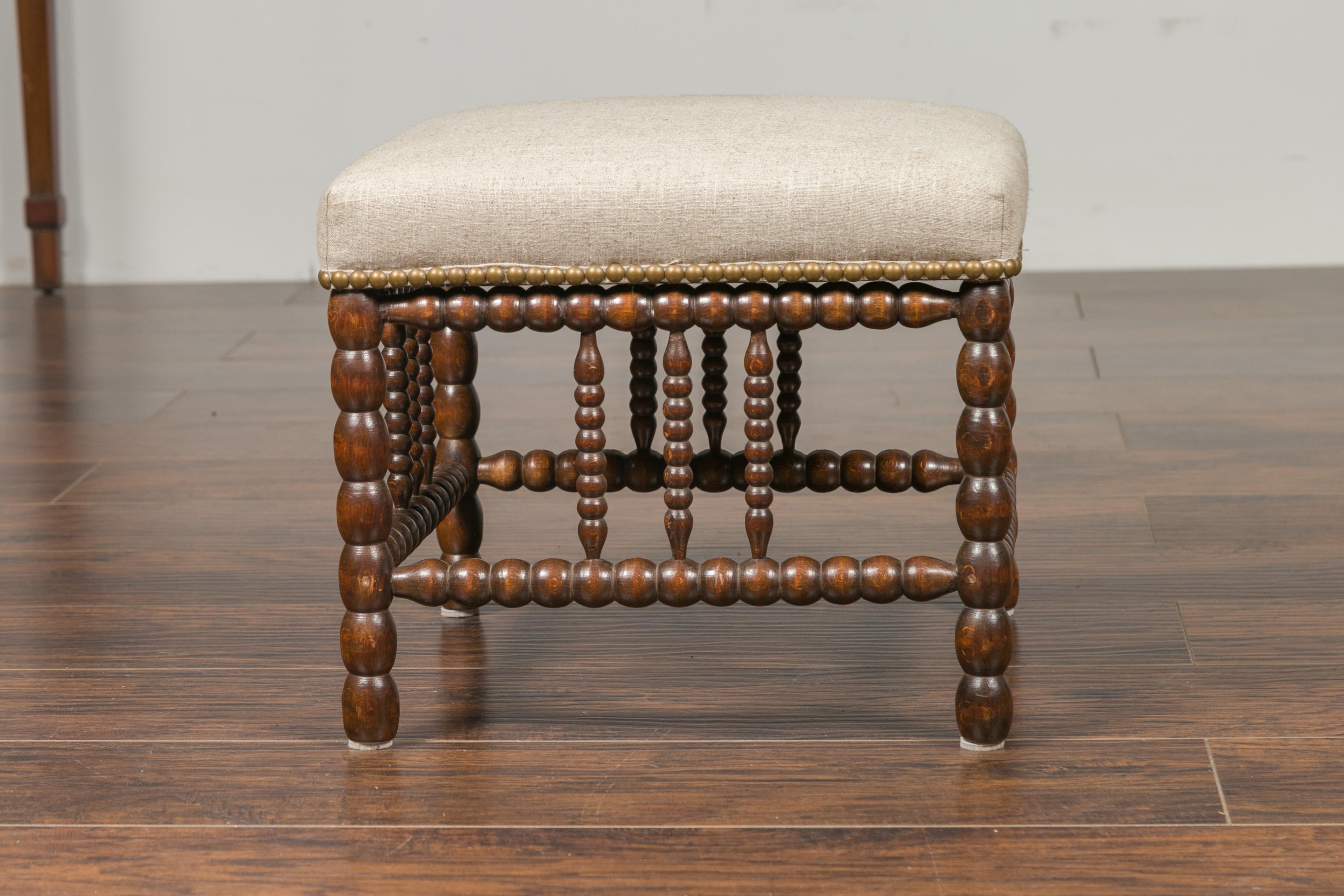 Turned English 1900s Oak Footstool with Bobbin Legs, New Upholstery and Nailhead Trim