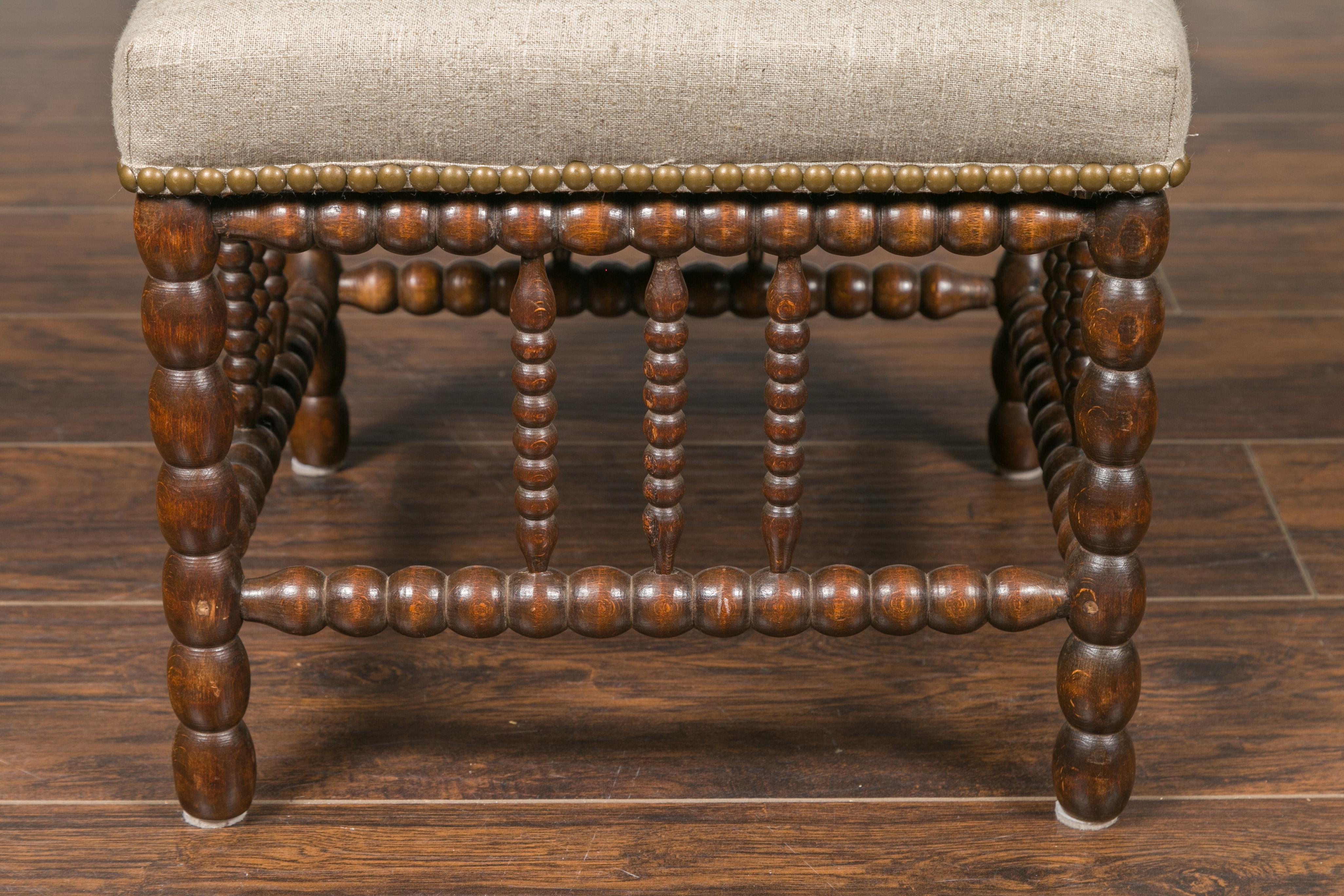 20th Century English 1900s Oak Footstool with Bobbin Legs, New Upholstery and Nailhead Trim