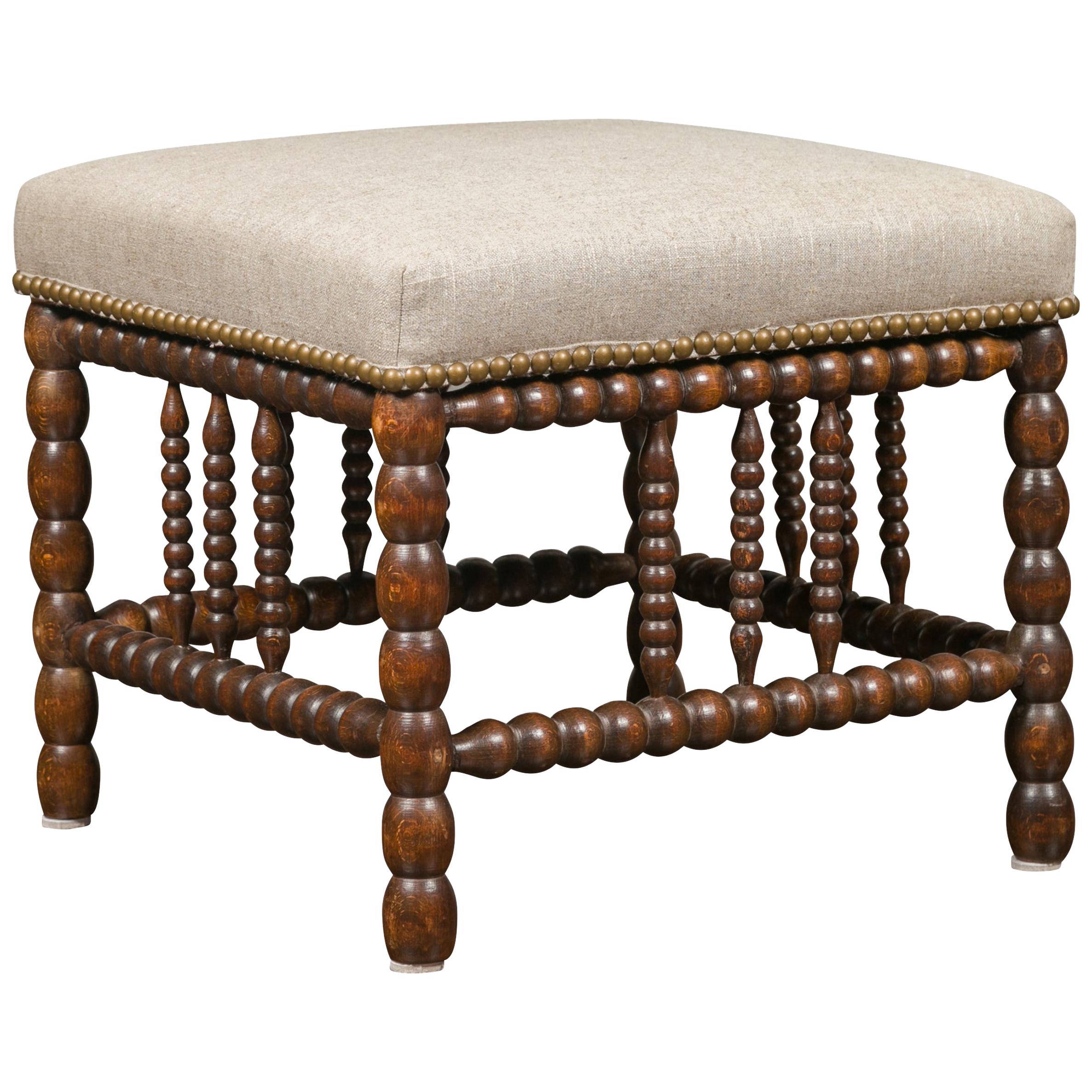 English 1900s Oak Footstool with Bobbin Legs, New Upholstery and Nailhead Trim