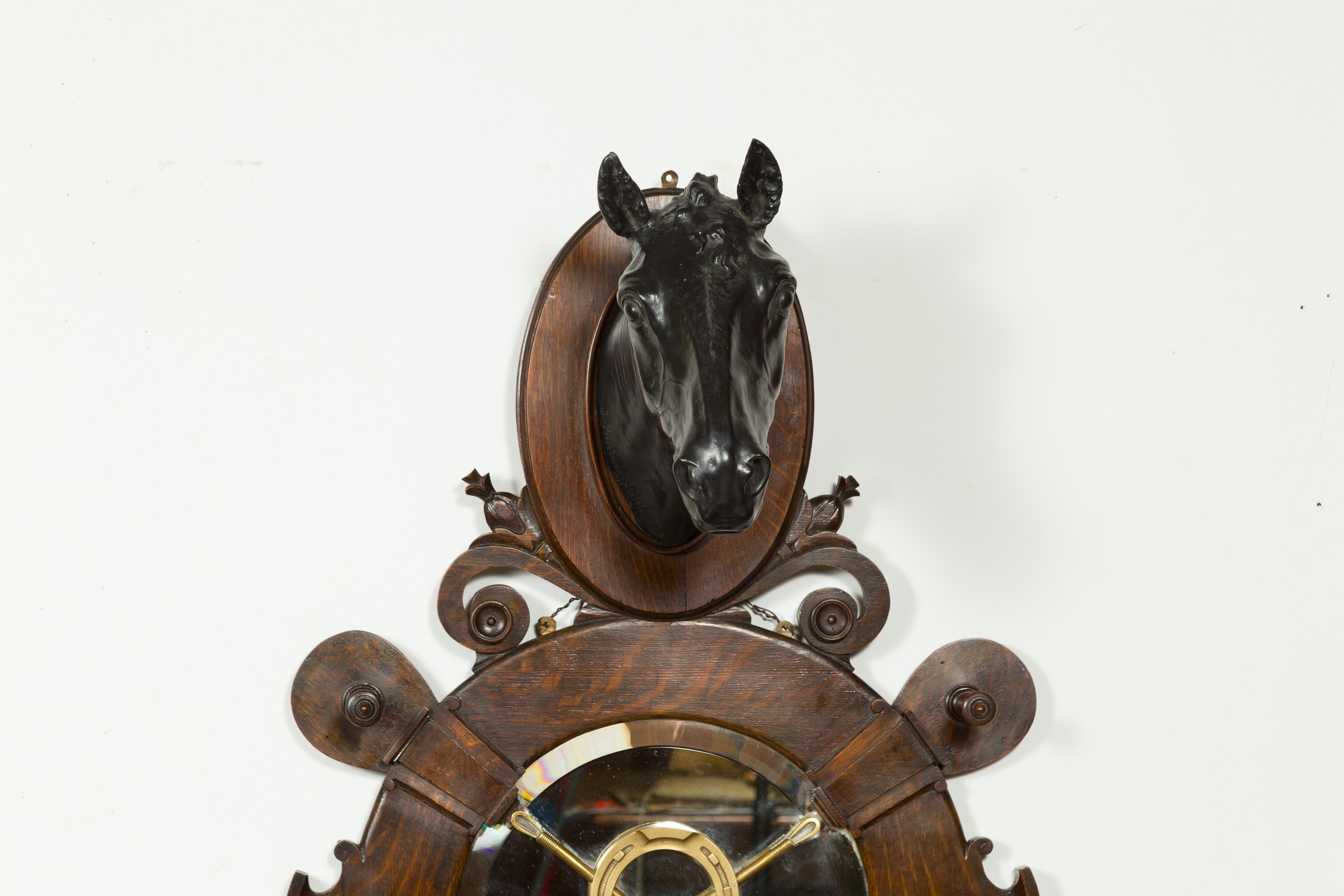An English wall hanging terracotta and oak horse with bronze accents, signed J. Priestman Sculptor circa 1903 and titled The Count. Created in the early years of the 20th century, this wall hanging fixture features a black terracotta horse head on