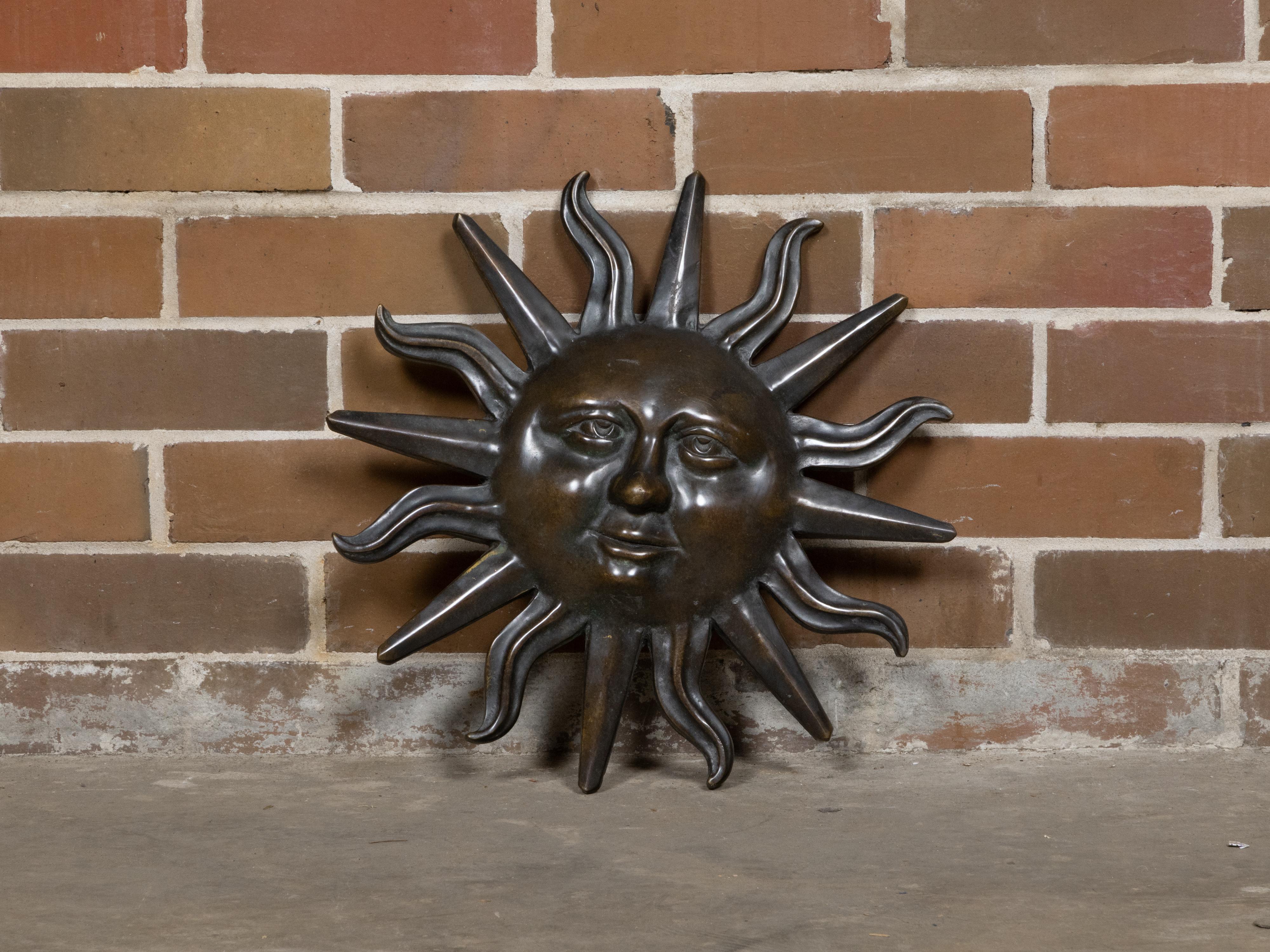 An English bronze sun wall ornament from circa 1920 with anthropomorphic features and dark patina. This captivating English bronze sun wall ornament from circa 1920 is an enchanting decorative element that brings a touch of historical charm to any