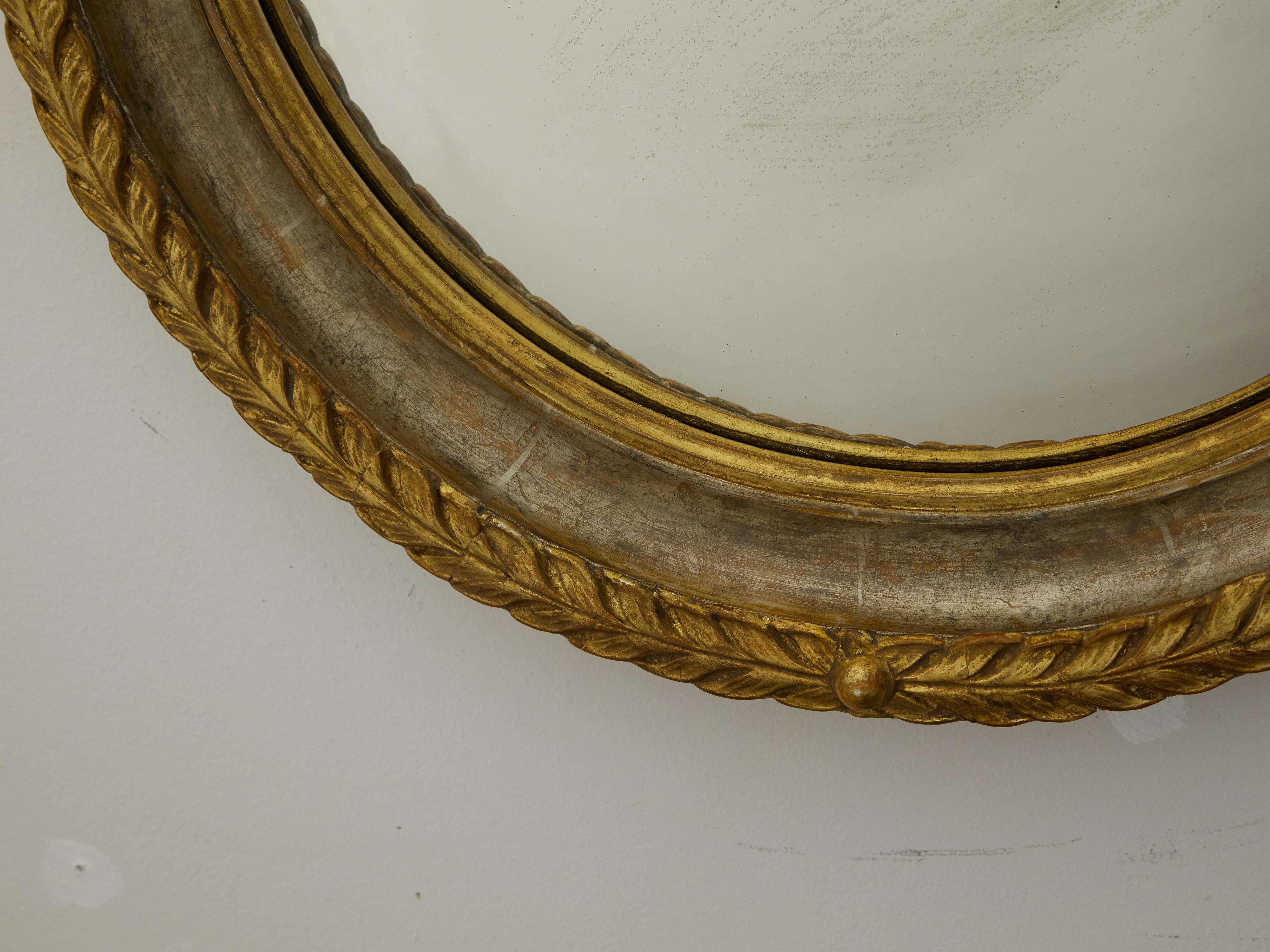 20th Century English 1920s-1930s Carved Wooden Round Mirror with Gilt Accents and Foliage