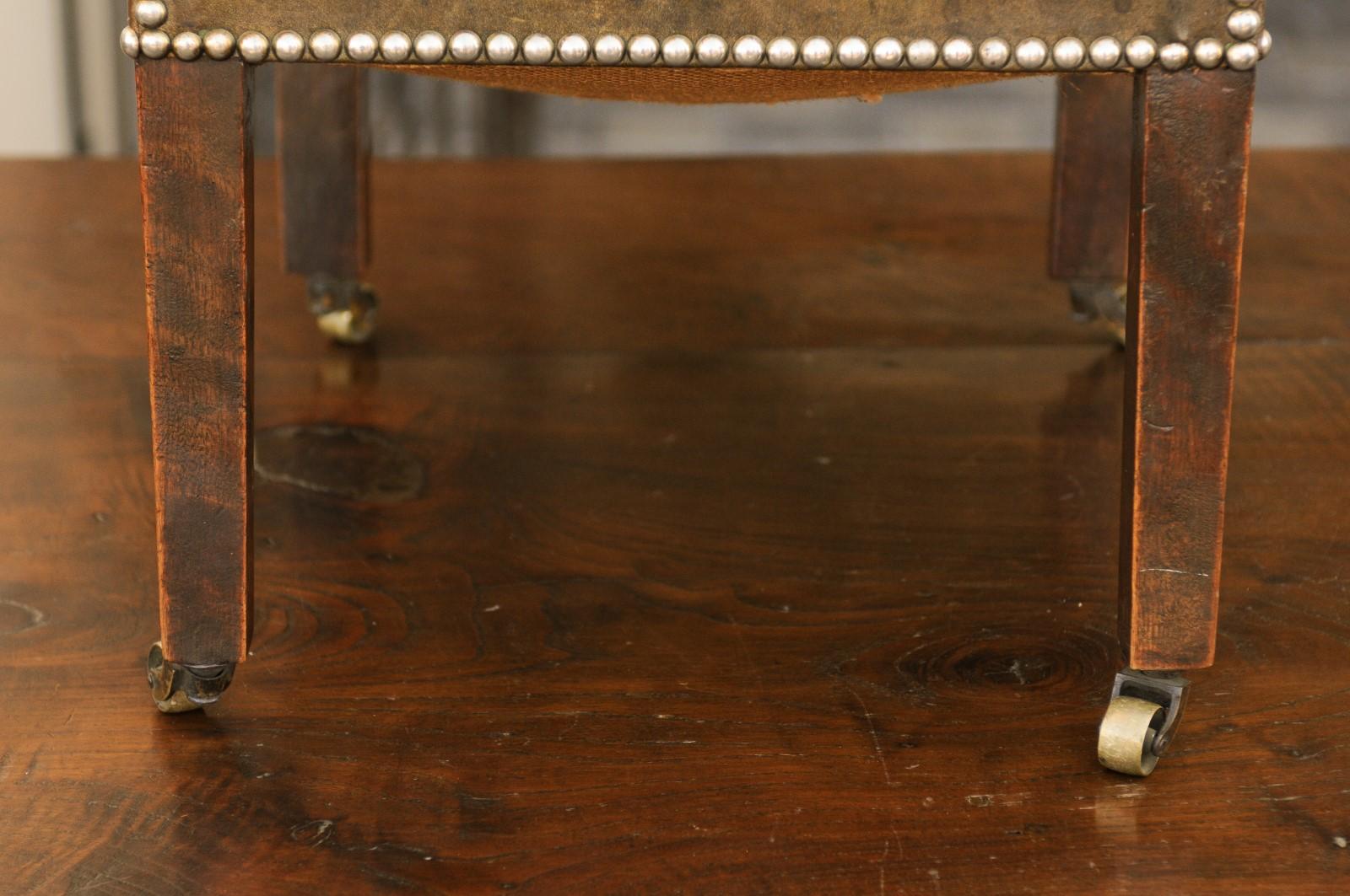 English 1920s Leather Gout Stool with Out-Scrolling Back, Nailheads and Casters 4