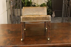 English 1920s Leather Gout Stool with Out-Scrolling Back, Nailheads and Casters