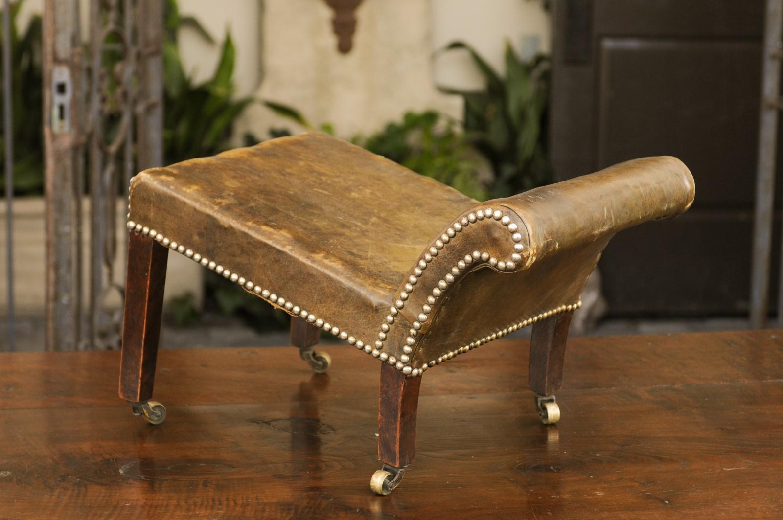 Brass English 1920s Leather Gout Stool with Out-Scrolling Back, Nailheads and Casters