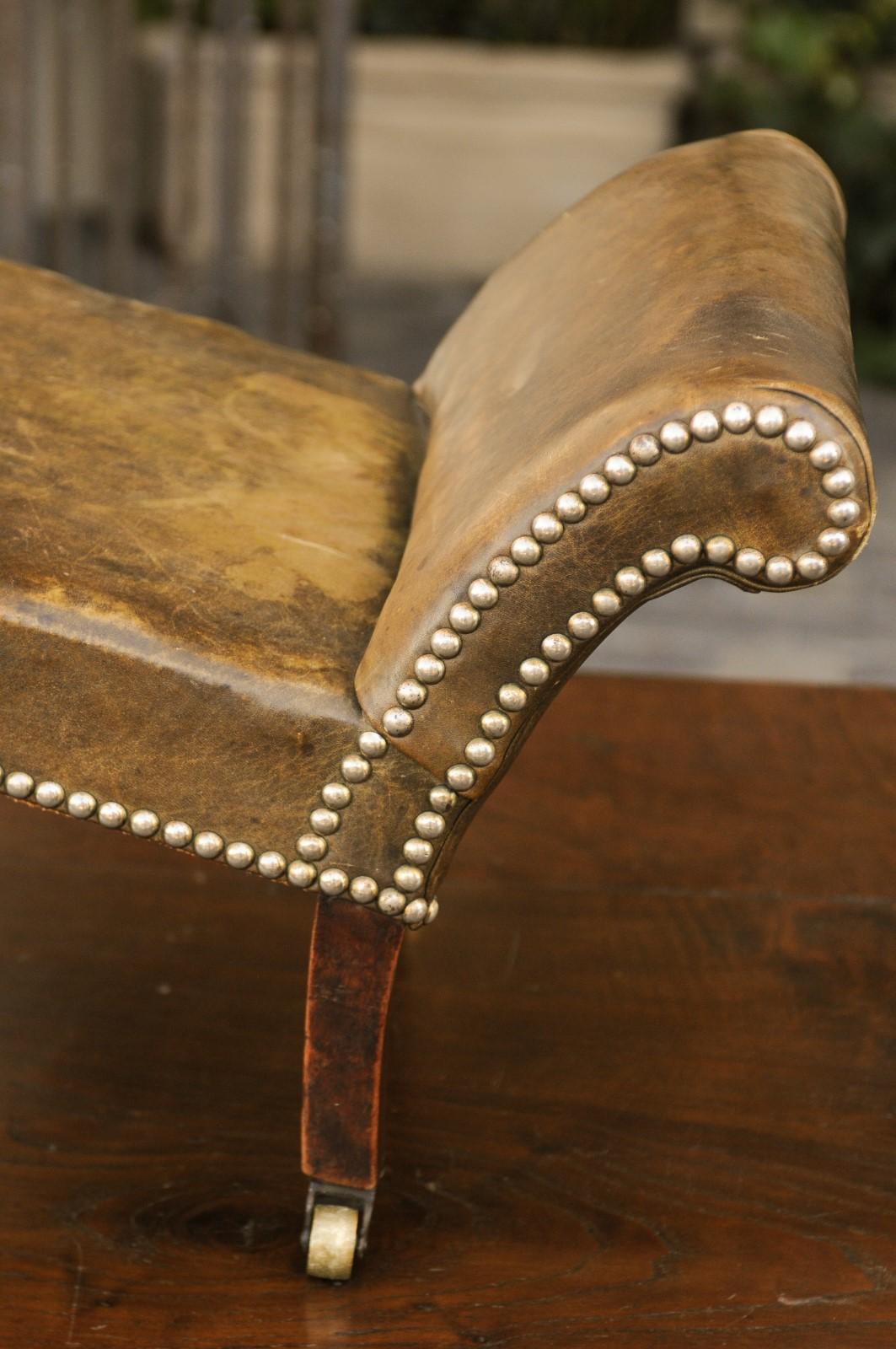 English 1920s Leather Gout Stool with Out-Scrolling Back, Nailheads and Casters 2
