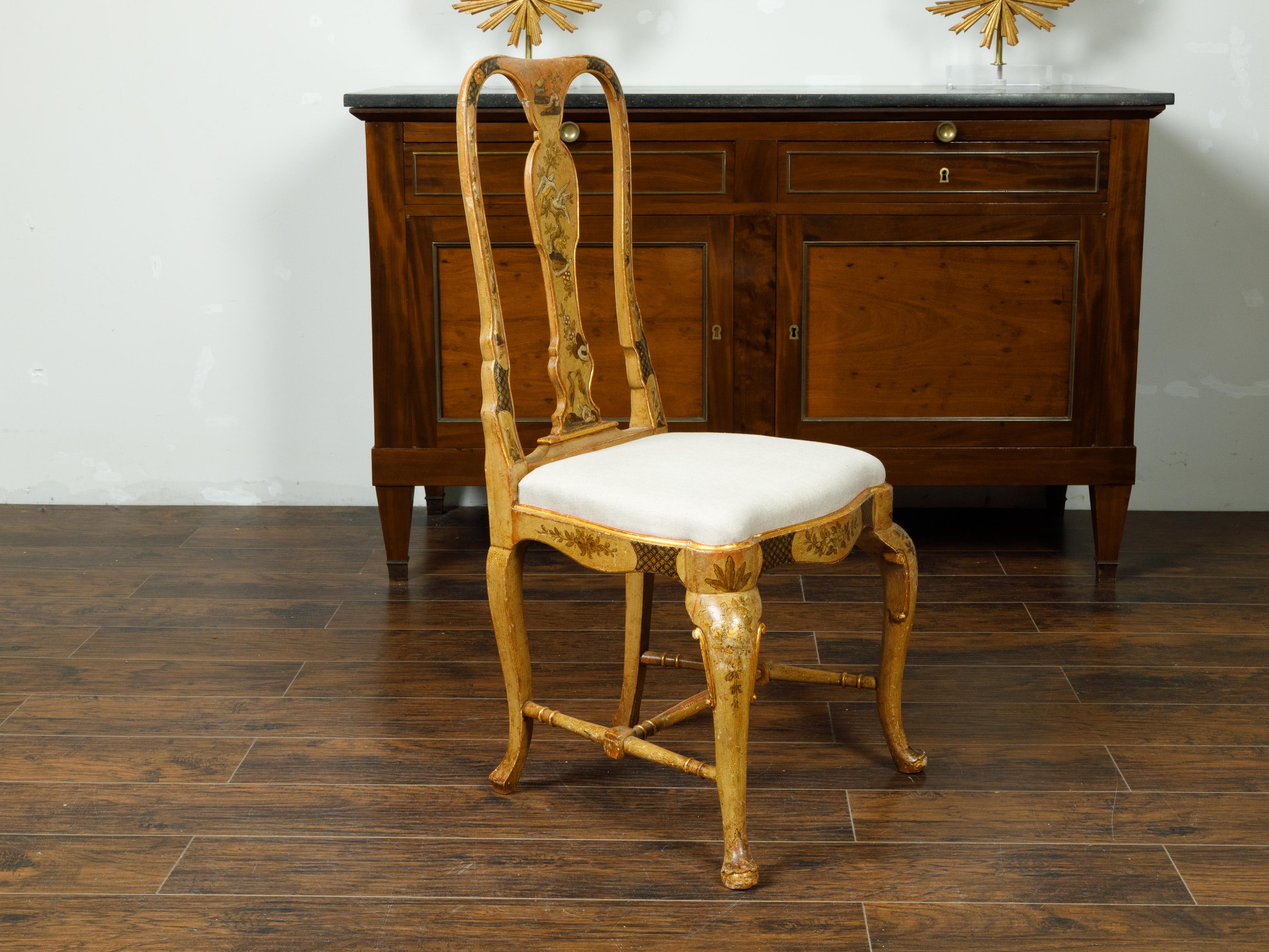 An English Queen Anne style side chair from the early 20th century, with painted bird and flower motifs. Created in England during the first quarter of the 20th century, this Queen Anne style side chair charms us with its sinuous lines and painted