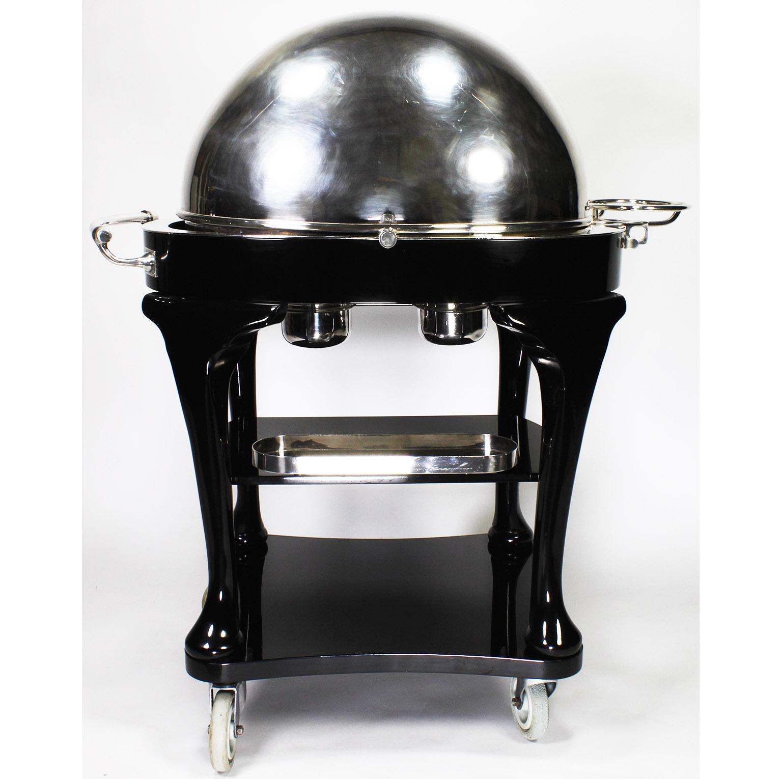 A Fine English 1930s Art Deco Ebonized and Silver Plated Beef/Turkey/Lamb Carving Trolley, by Drakes Silversmiths of Brewer Street, London W1. The elegant silver-plated domed-top cart, surmounted atop a mahogany frame, with a hot-water reservoir and