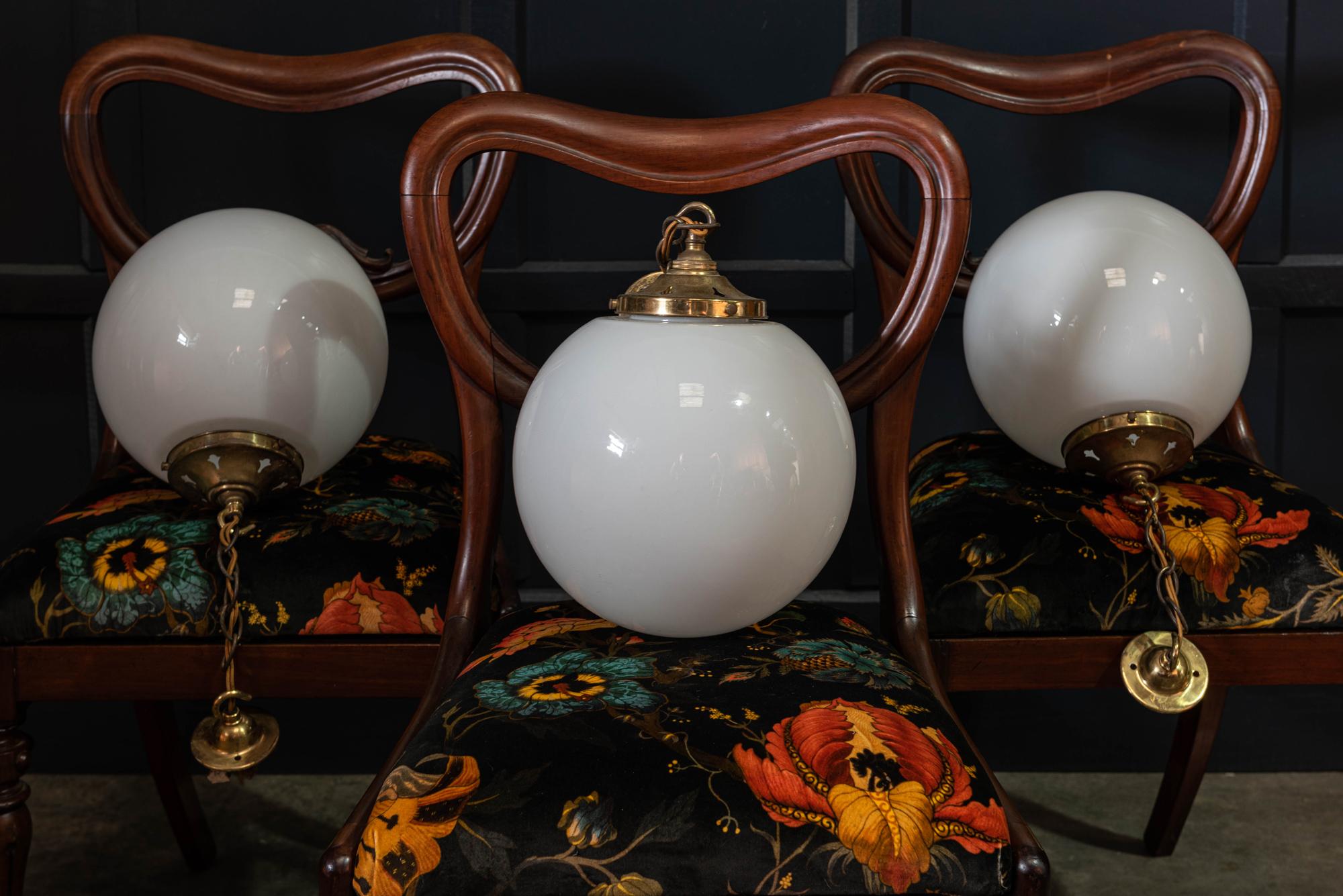 Set of three English opaline globe pendants with original galleries, chain and ceiling hooks,

circa 1930

Price is for three.

Measures: 25cm diameter.