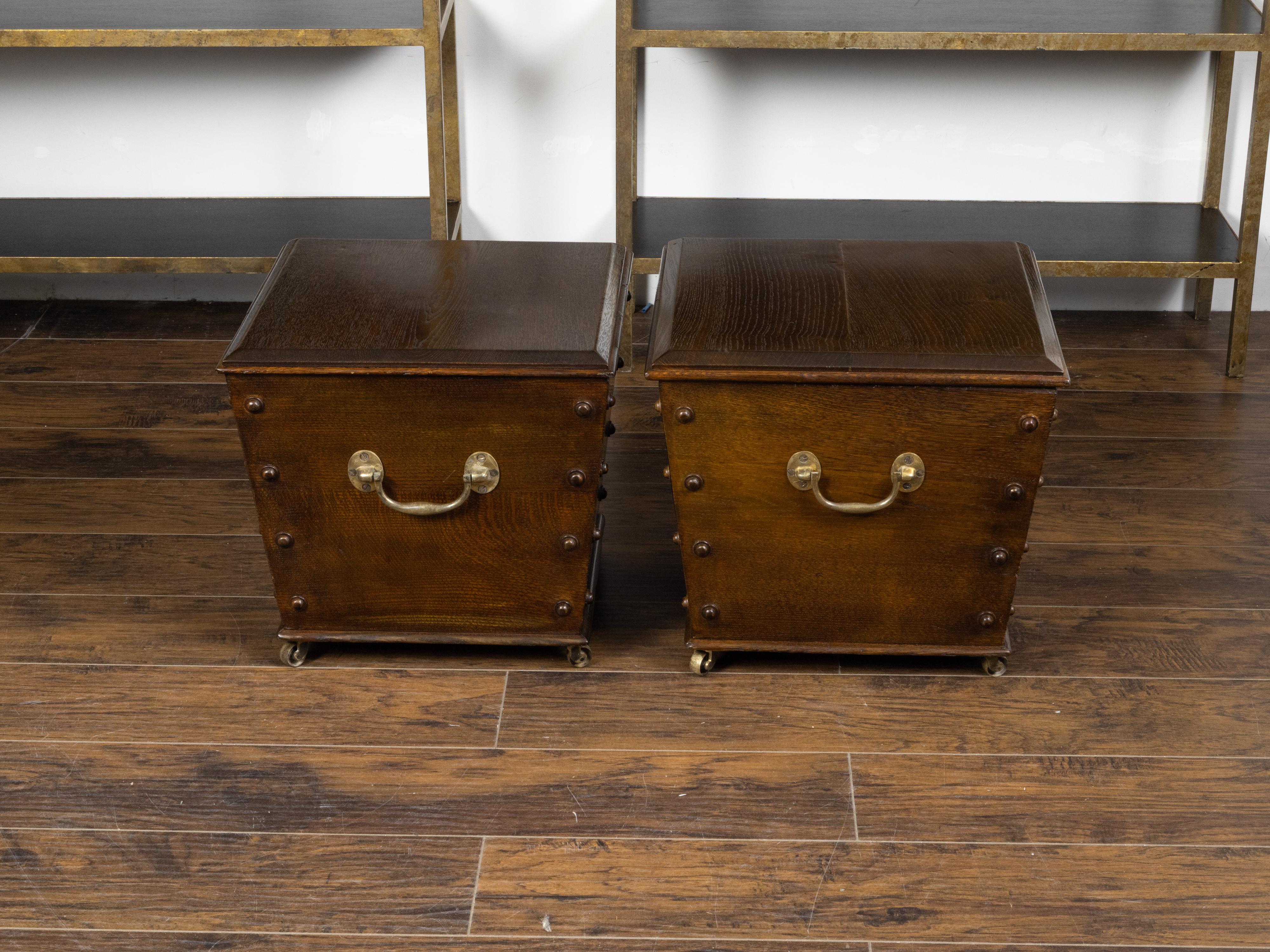 Two English vintage oak cellarettes from the mid 20th century with brass hardware, sold individually $3,995 each. Created in England during the first half of the 20th century, these cellarettes each feature a square top with beveled edges opening to