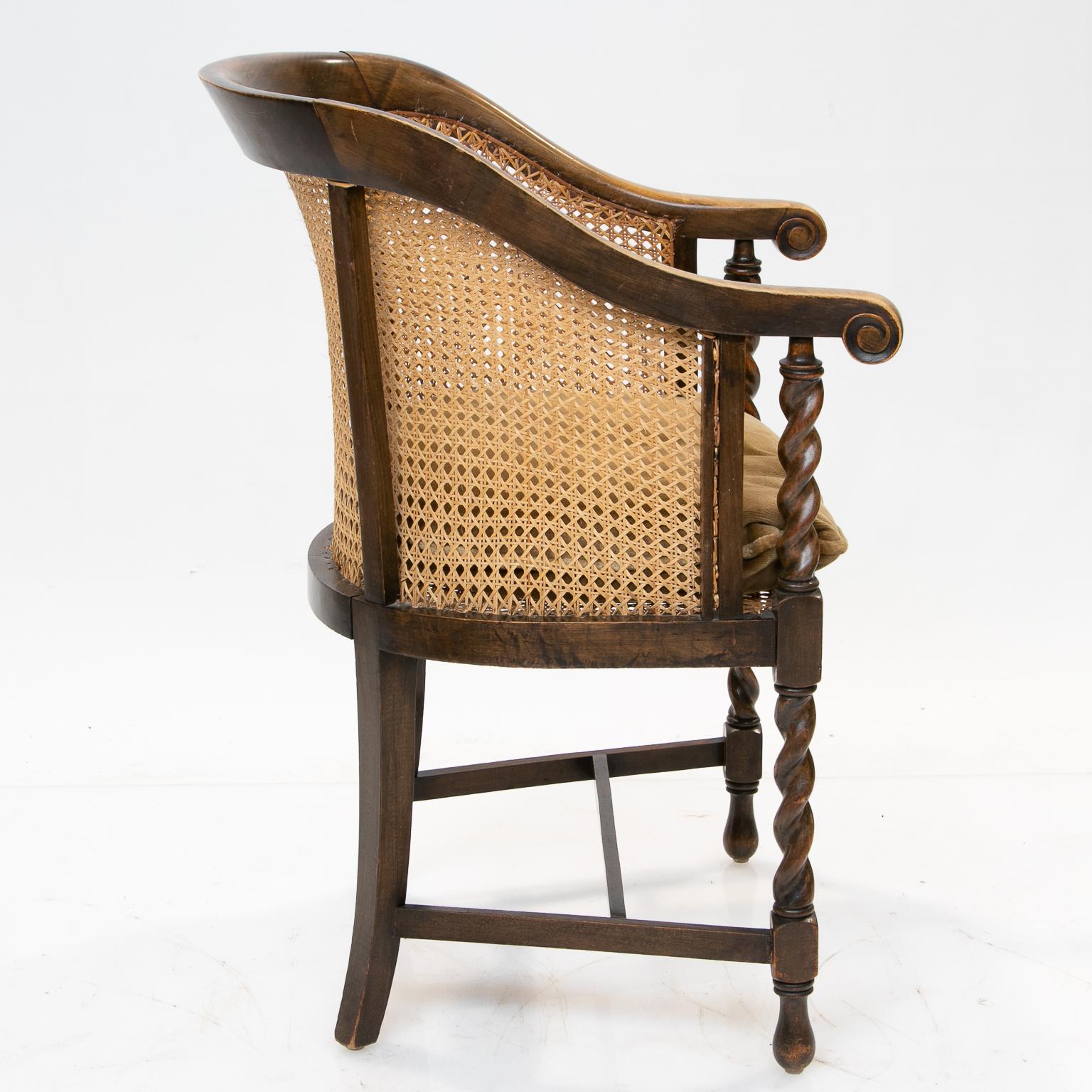 English 19th century barrel back armchair
This chair is a great accent piece for multiple uses. From England and made of elm and walnut with newly cane seat and back. Luxurious patina and color. This has a comfortable barrel back and a new cushion