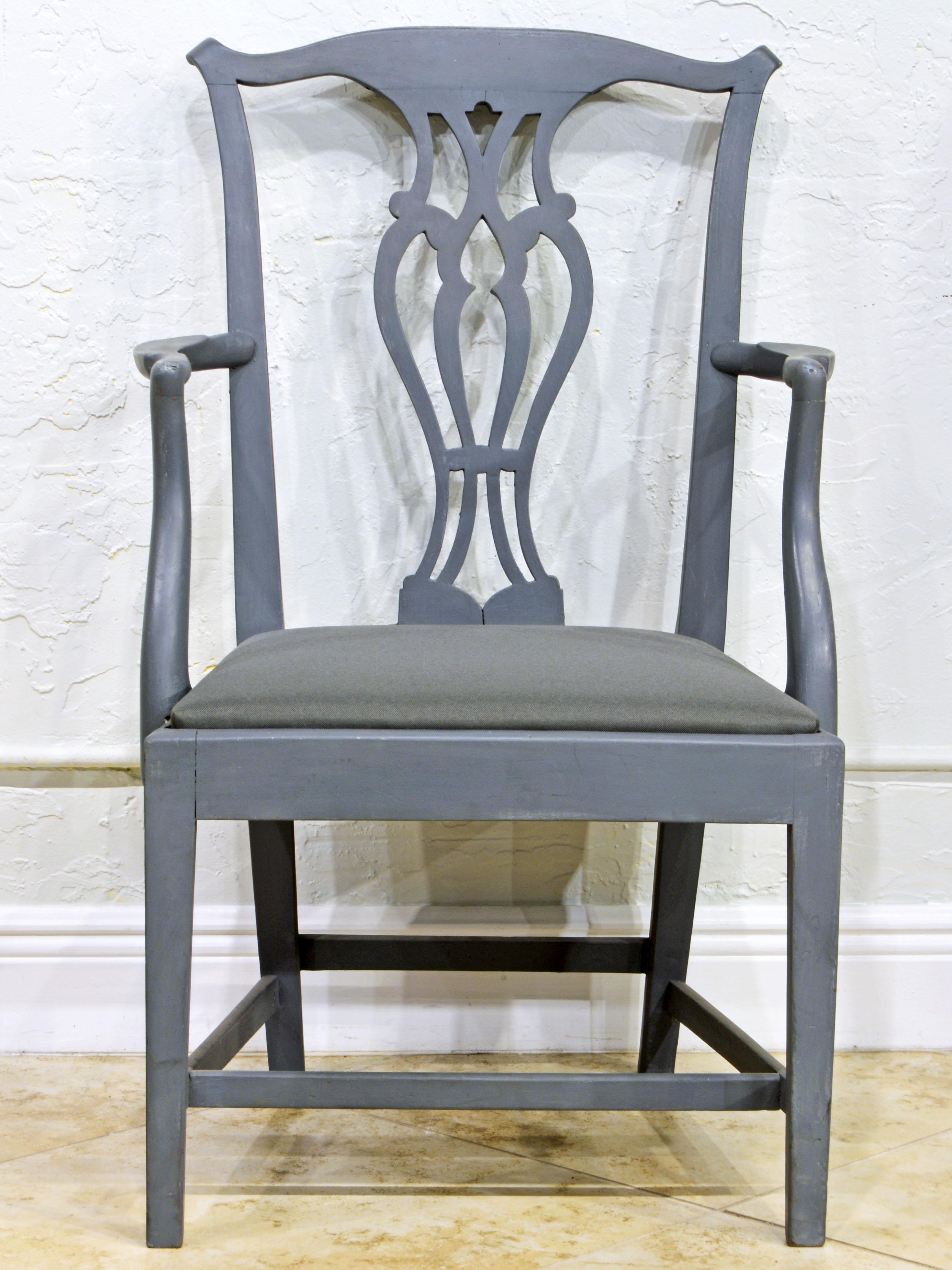 This English carved Chippendale style armchair is painted in a Gustavian gray color with slight distress. The seat has been recovered with a matching gray fabric to add a modern feel.