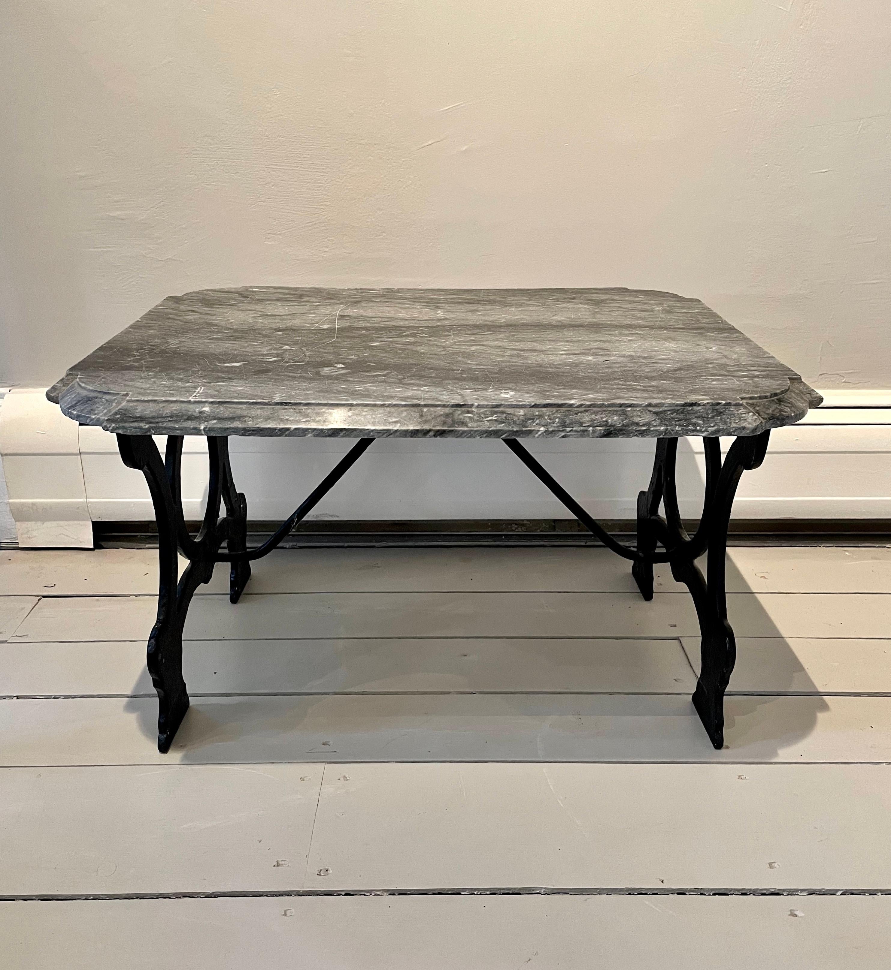 This is a charming and quirky little table that is just perfect for holding coffee and the Sunday papers (does anyone do that anymore?) next to your favorite library chair. In two parts, the original grey cut-corner and beveled striated marble top