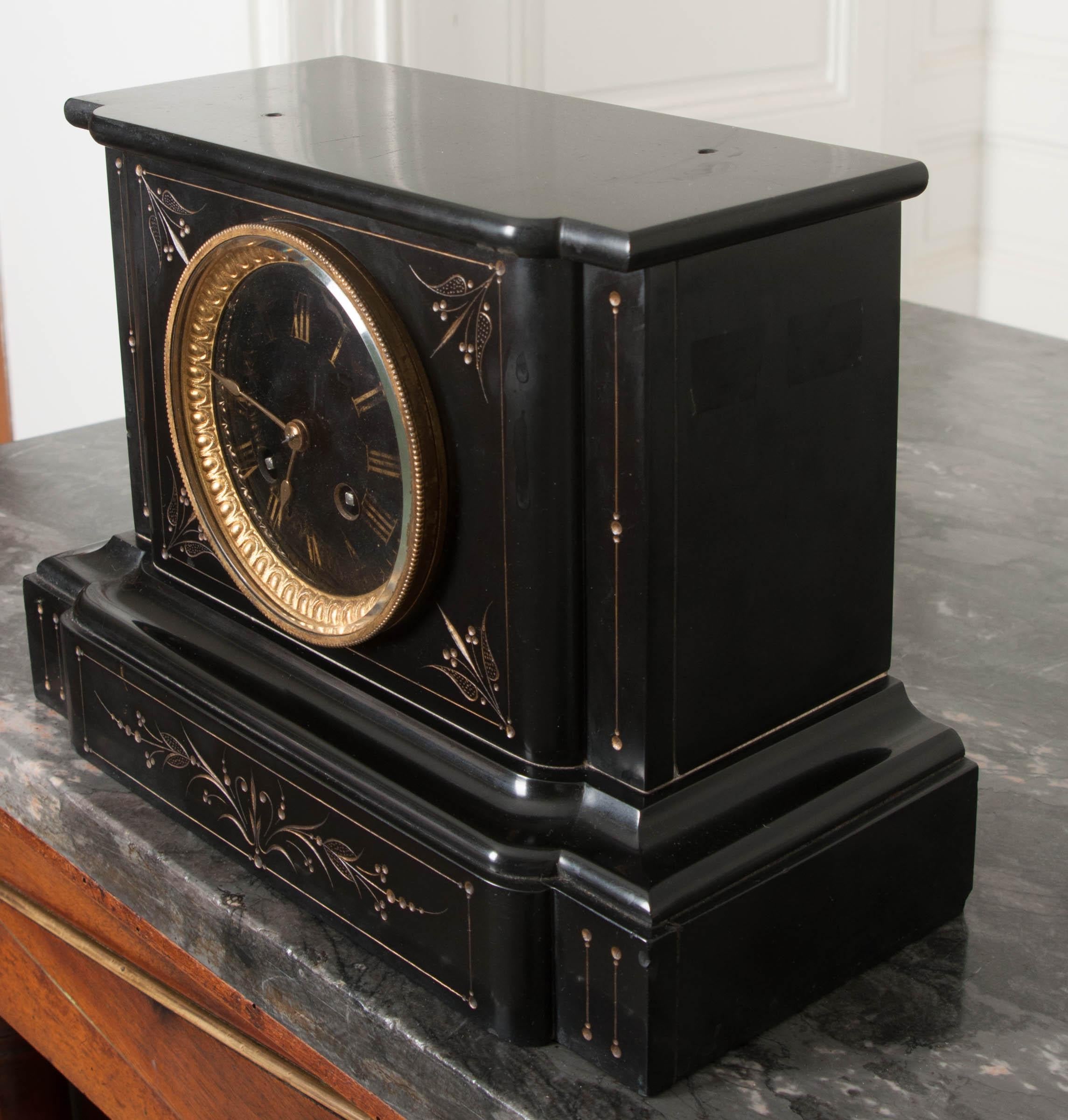 This lovely French, Paris Movement mantel clock, c. 1880, with incised and gilt decoration, is of square section on a stepped plinth base and features an enamel dial with hand-painted Roman numerals and gilt-brass bezel with the original convex