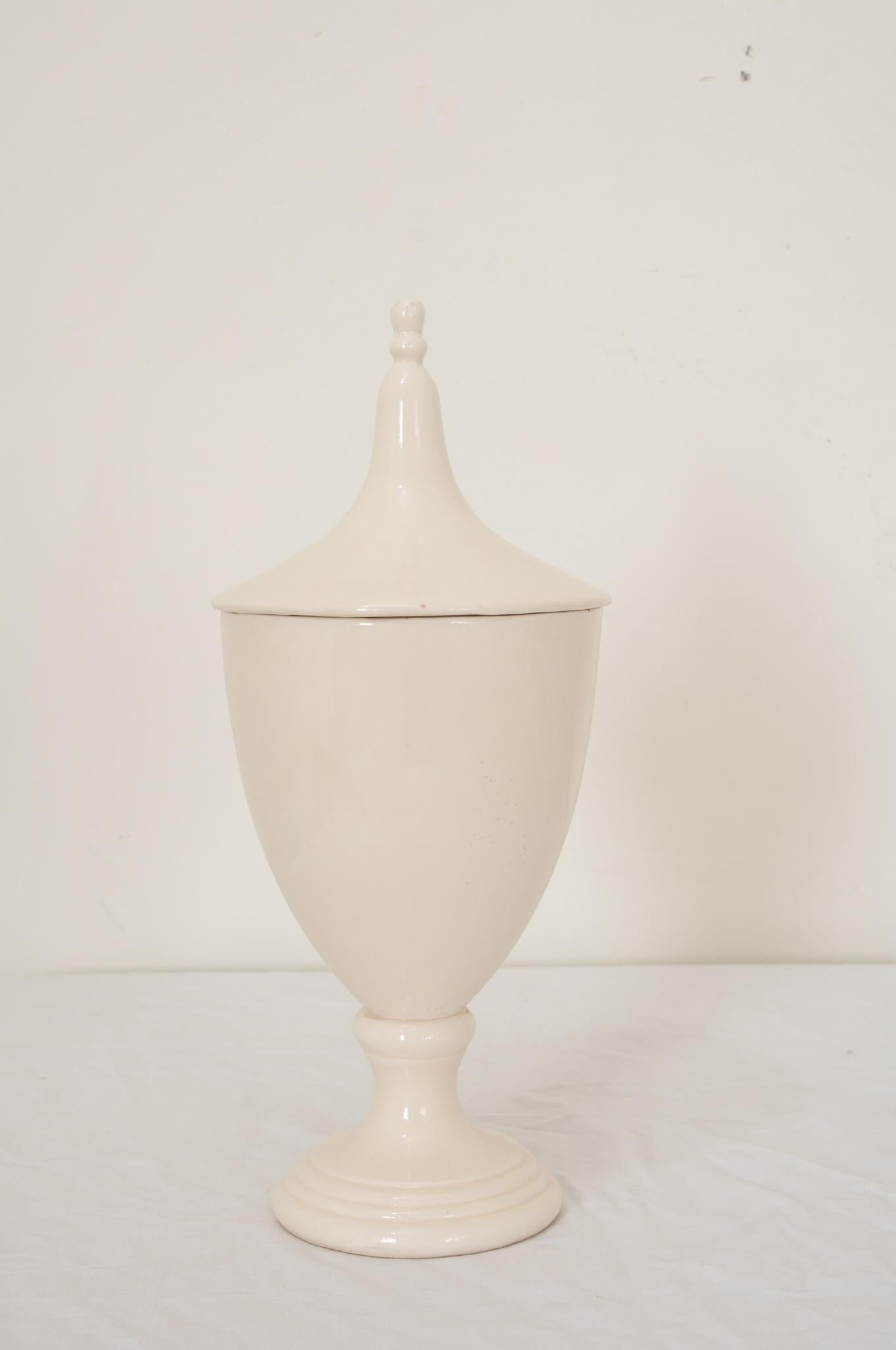 An English 19th Century apothecary or herbalist jar of white ceramic in the shape of a classical urn. Jars were used by apothecaries in pharmacies and dispensaries in hospitals and monasteries. Apothecaries needed containers to store herbs, roots,