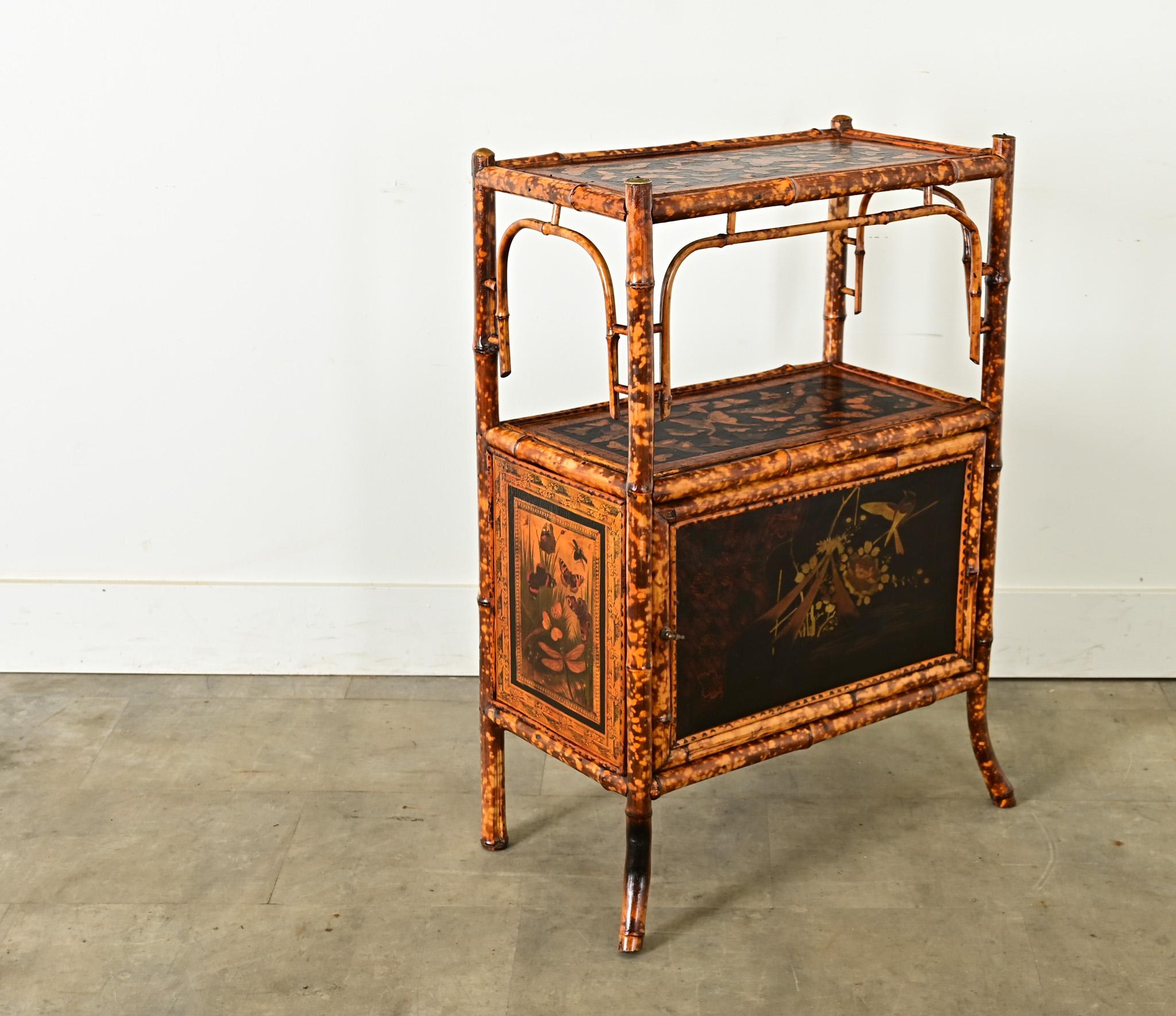 This late 19th century English Victorian Aesthetic Movement side table-cabinet has received an exciting update with recent butterfly decoupage! Hand-crafted in exotic tiger bamboo, which complements the golden yellow illustrations of the butterflies