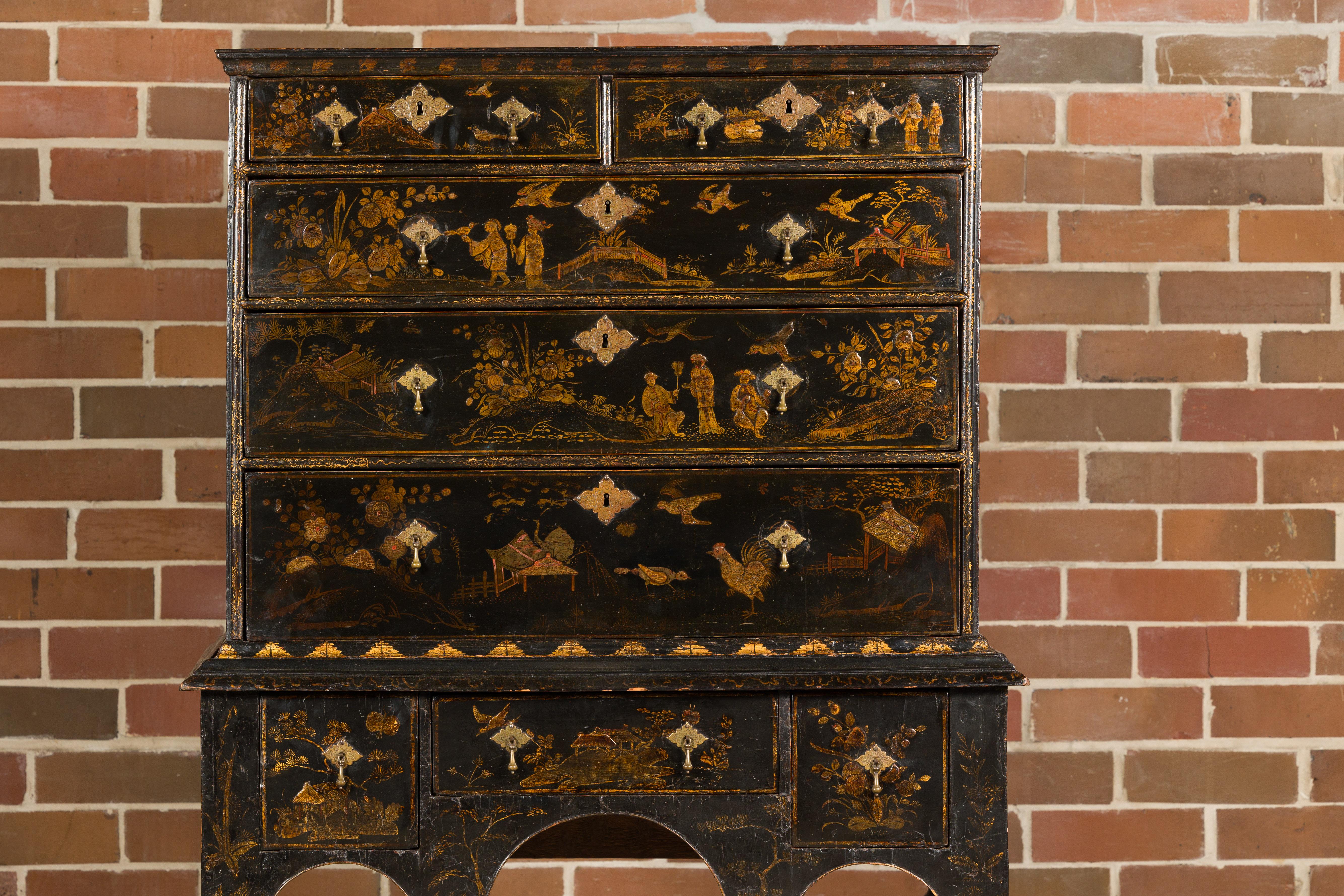 An English black and gold Chinoiserie highboy chest from the 19th century with eight drawers, tapered hexagonal legs, low stretchers and bun feet. Delve into the opulence of the Orient with this striking 19th-century English Chinoiserie highboy