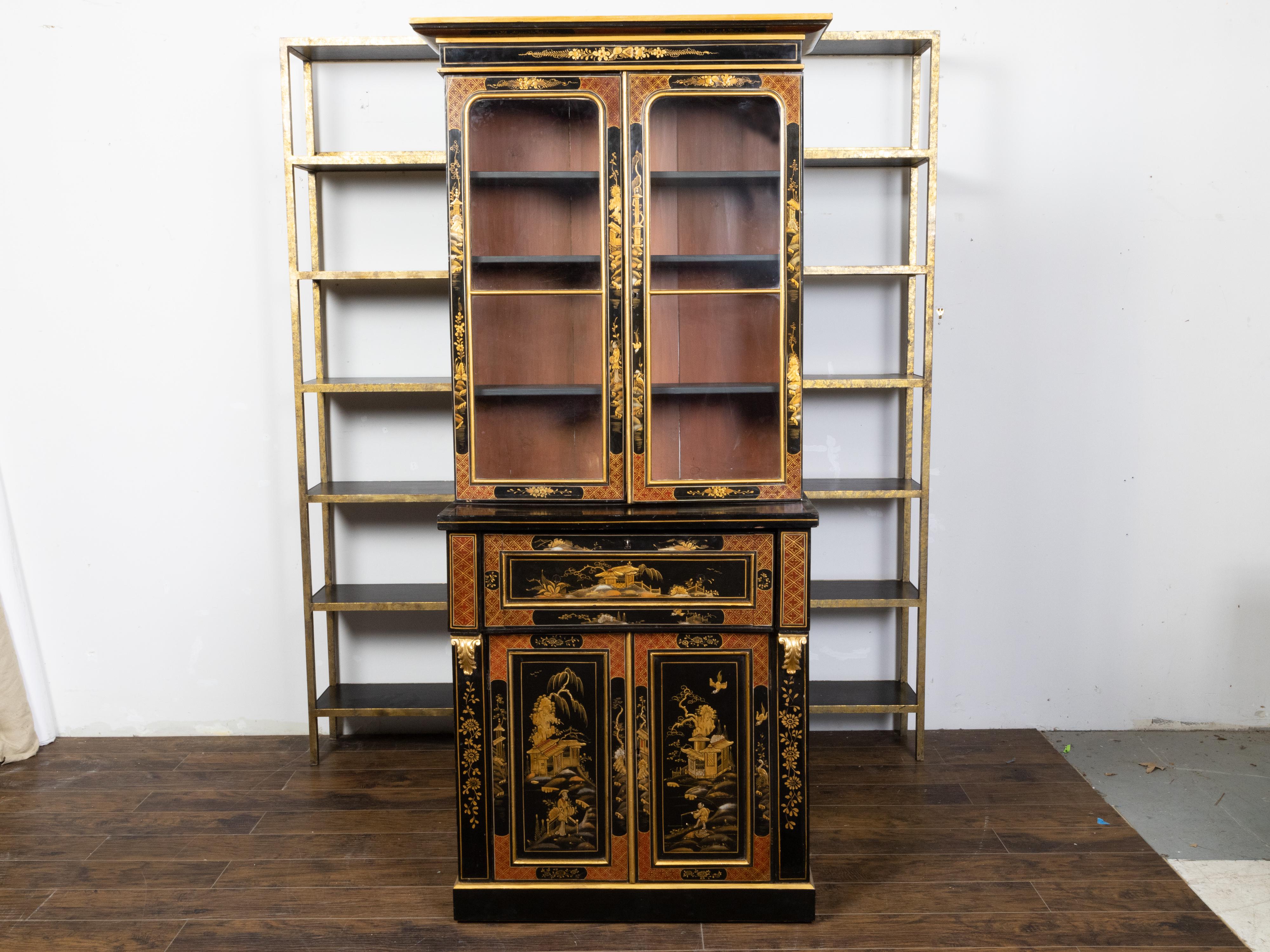 An English black lacquer secretary bookcase from the 19th century, with glass doors, drop-front desk and gold Chinoiserie décor. Created in England during the 19th century, this secretary bookcase draws our immediate attention with its black