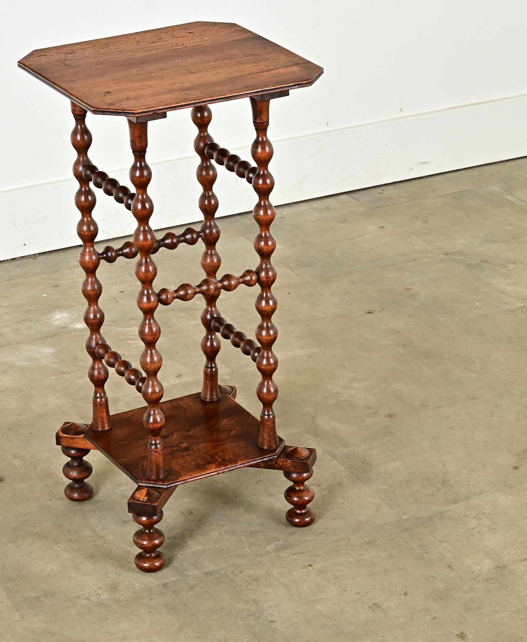 This playful English bobbin table is perfect for adding character and antique charm to your interior. The single board solid oak top rests over tall turned bobbin legs raised on a plinth base with turned bobbin feet. Cleaned and polished with a