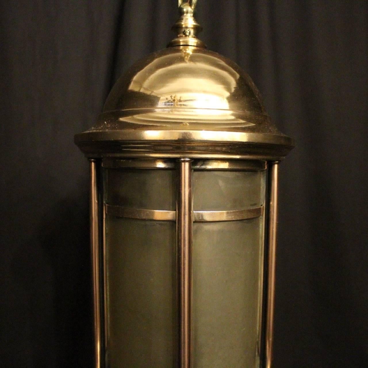An English single light bronze exterior lantern, the single inverted light fitting surrounded by a single convex etched glass panel and held within a bronze cast framework with domed top and ball terminals, repolished and lacquered, excellent