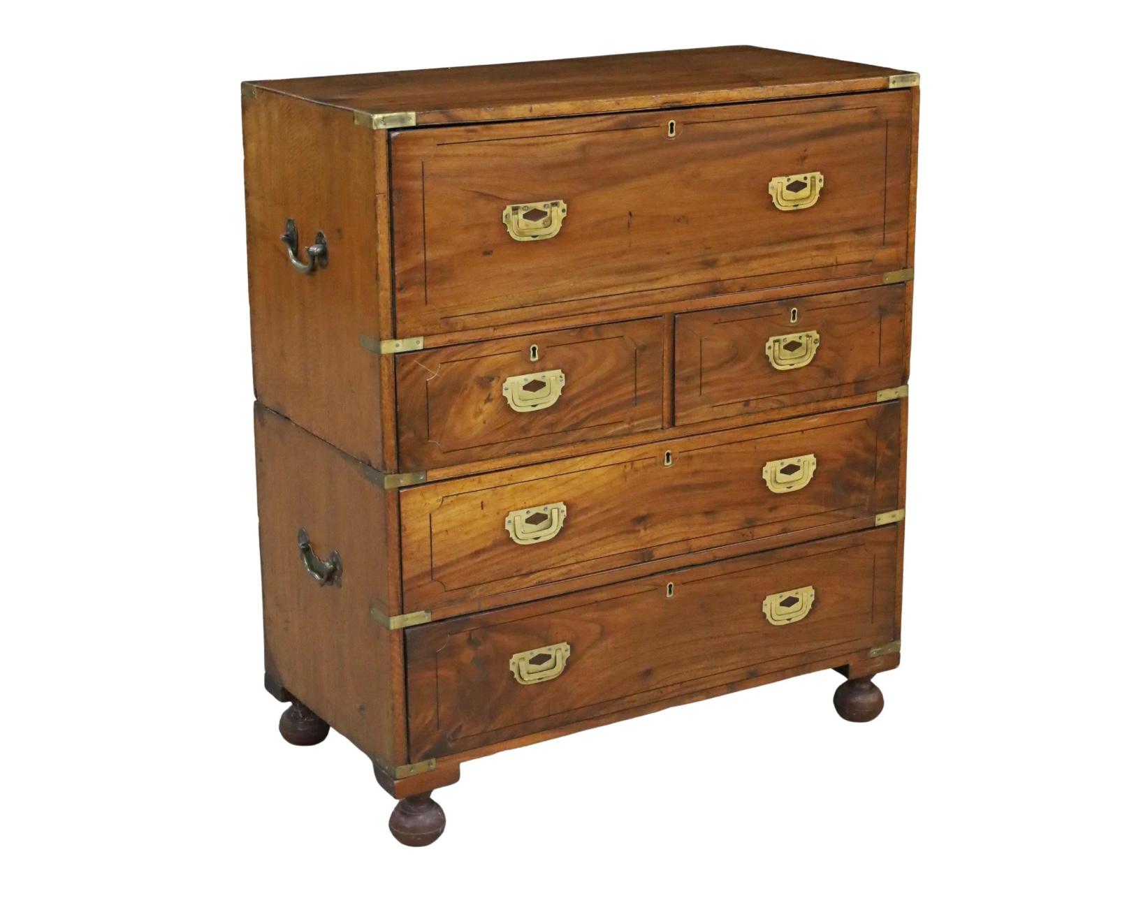 This handsome 19th century English camphor wood two-part Campaign Chest features the original solid brass corner mounts, escutcheons and hardware, including the signature lift handles commonly associated with campaign style. This chest comes in two