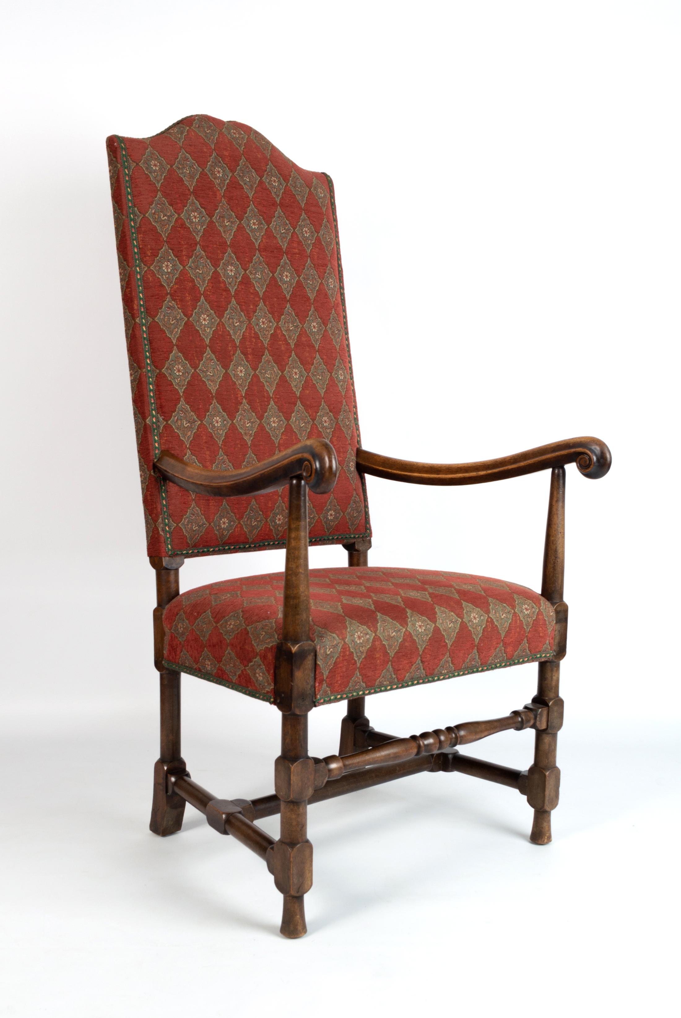 A CHARLES II STYLE MAHOGANY HIGH BACK ELBOW CHAIR,
ENGLAND, 19TH CENTURY.

Humped back, upholstered to the back and seat in red fabric with a lozenge design, the arms of scrolling form, the legs joined by stretchers.
In excellent condition