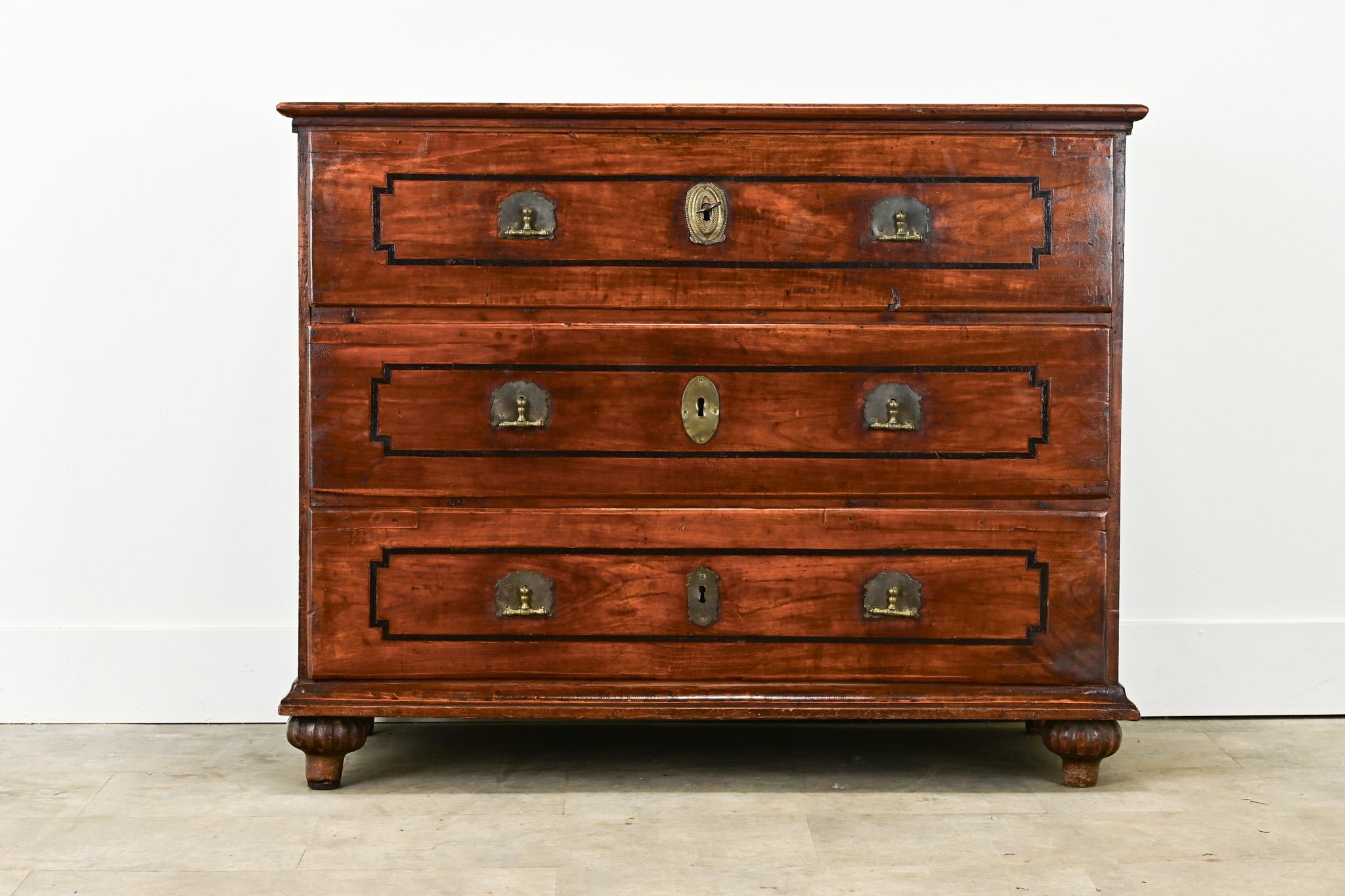 An impressive English chest made from solid wild cherry. The top of the chest has an inlay ebonized banding design, also found on all three drawer fronts. The three easy-to-use drawers have brass two-finger drop pulls and repurposed hand-cut