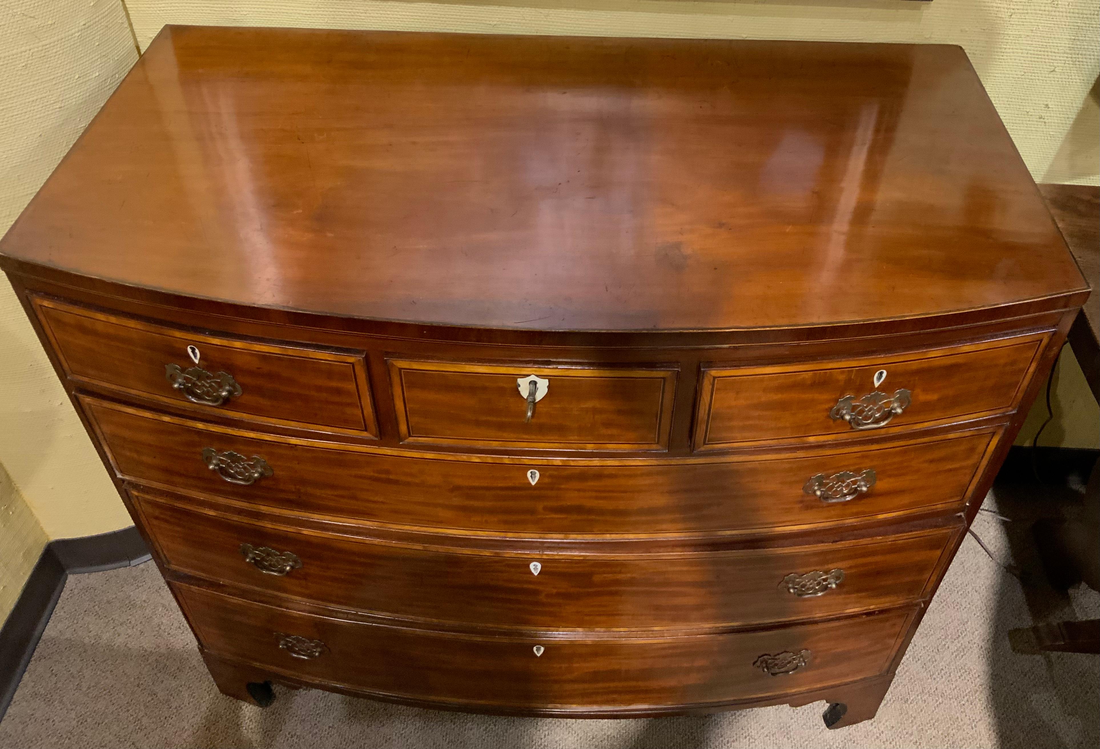 Handsome chest of drawers having three drawers across the top
And three larger drawers under the upper section. All drawers
slide easily and all drawers have a decorative line of ebony
And satinwood. The hardware is original. The chest rests on